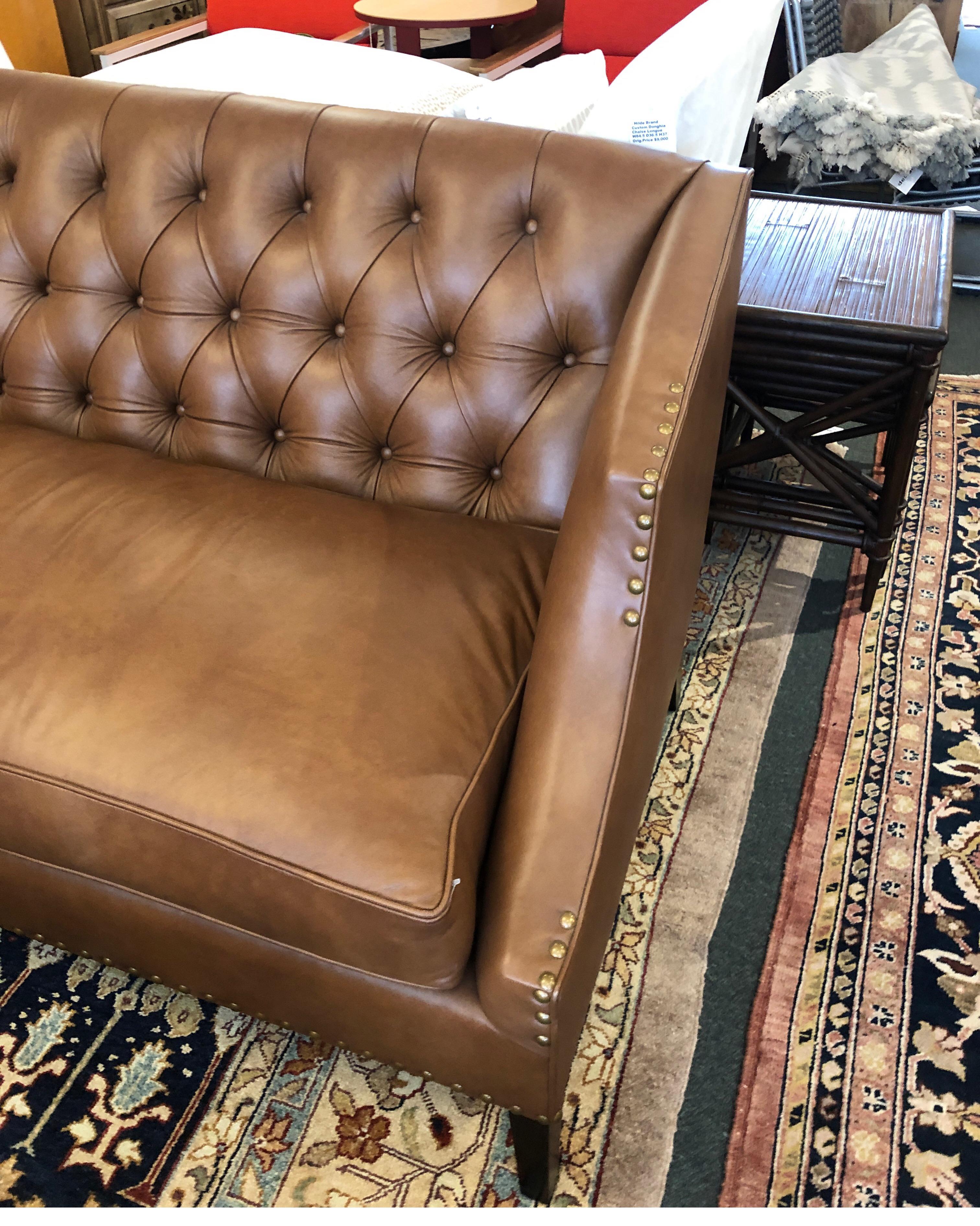 It presents a new becki sofa from leathercraft. Beautiful tufted terracotta leather is the star on this Classic piece, with antique pewter nailhead detailing. Tapered maple legs are finished for subtle contrast. Seat cushion is feather and fiber