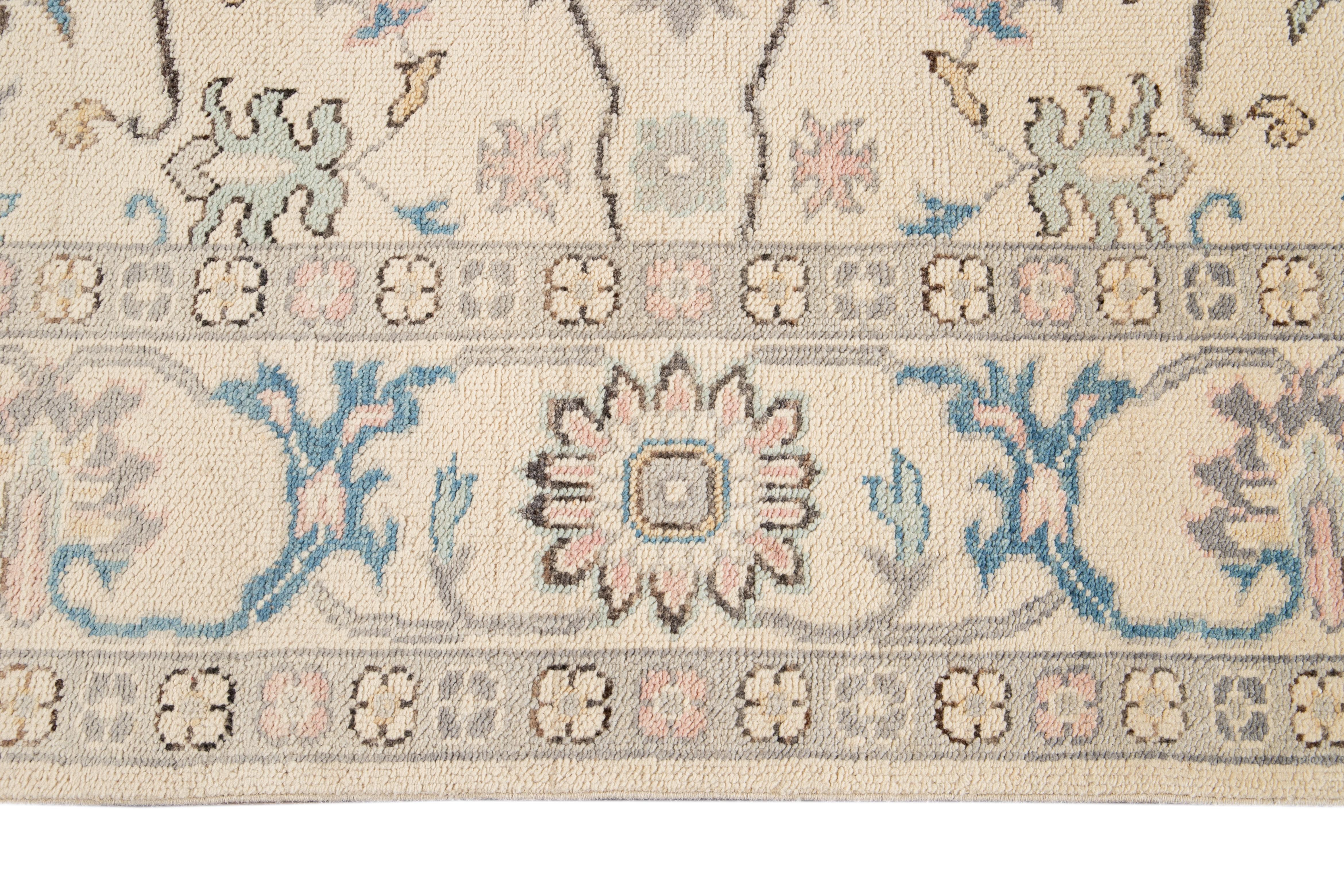 Beautiful square modern Oushak hand knotted wool rug with a botanical floral design on a beige field and multi-color accents throughout the piece. 

This rug measures: 8'2