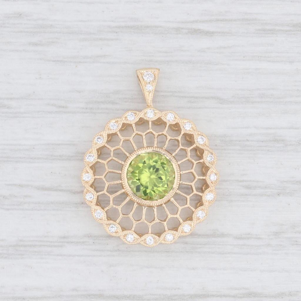 Gem: Natural Peridot - 1.26 Total Carats, Round Brilliant Cut, Light Green Color
- Natural Diamonds - 0.12 Total Carats, Round Brilliant Cut, F - G Color, VS2 Clarity
Metal: 14k Yellow Gold
Weight: 2.1 Grams 
Stamps: 14k
Measurements: 23.3 x 17.8 mm