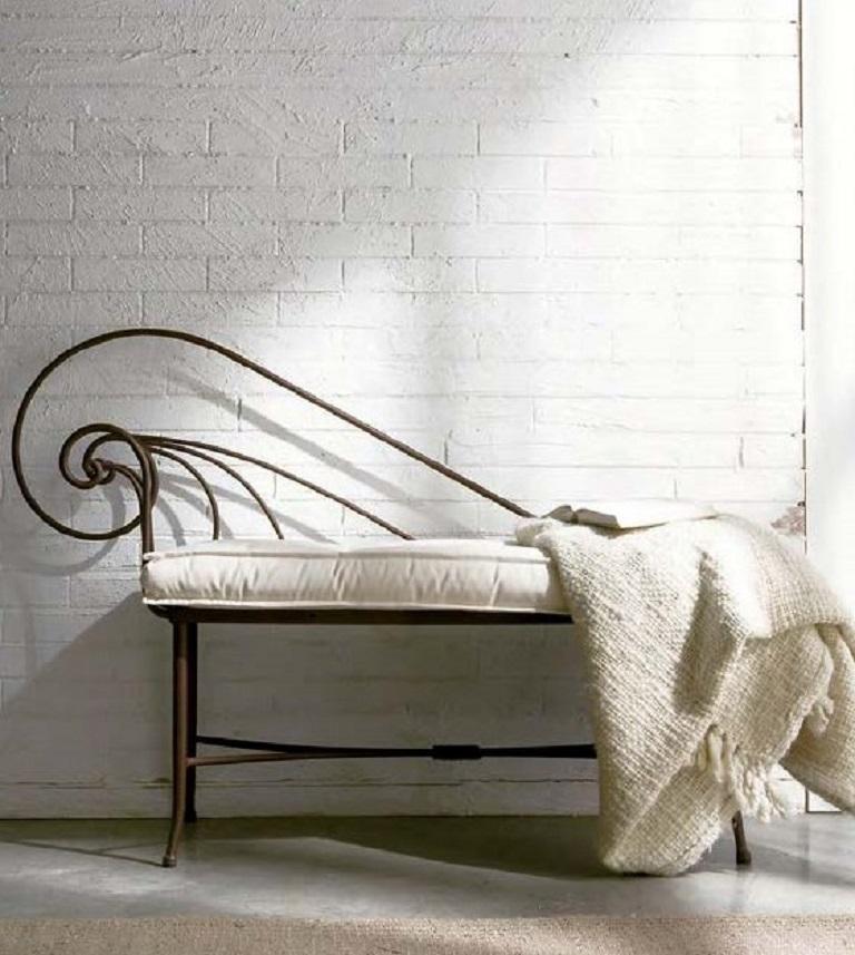 A wonderful French wrought iron Baguès style bench with lattice seat and scrolled arm.
Cushion included.