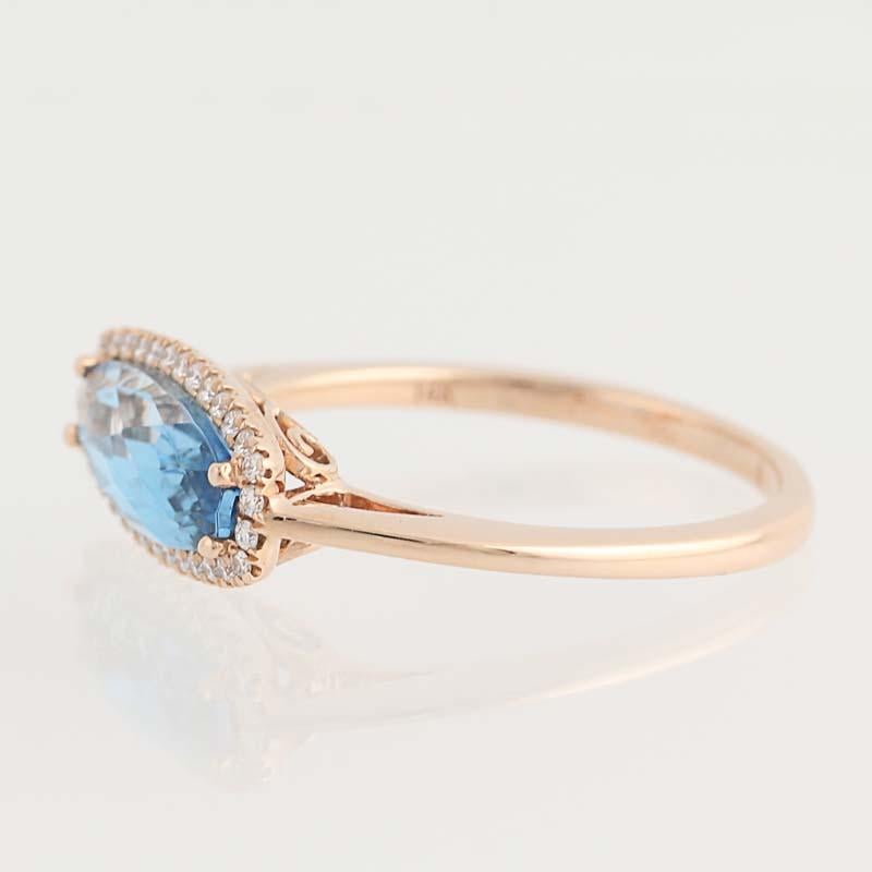 Searching for the perfect birthday or holiday gift for a special someone? Your quest ends here with this gorgeous ring! Fashioned in beautiful 14k rose gold, this NEW piece features a genuine blue topaz framed in natural diamond accents. The