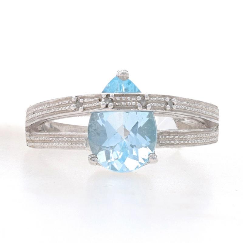 This unique piece is sure to please! The sterling silver ring features a 3.50ct pear cut genuine blue topaz in an open cut split band setting. The band has a contemporary style with textured bead work accenting and one band crossing over the stone.