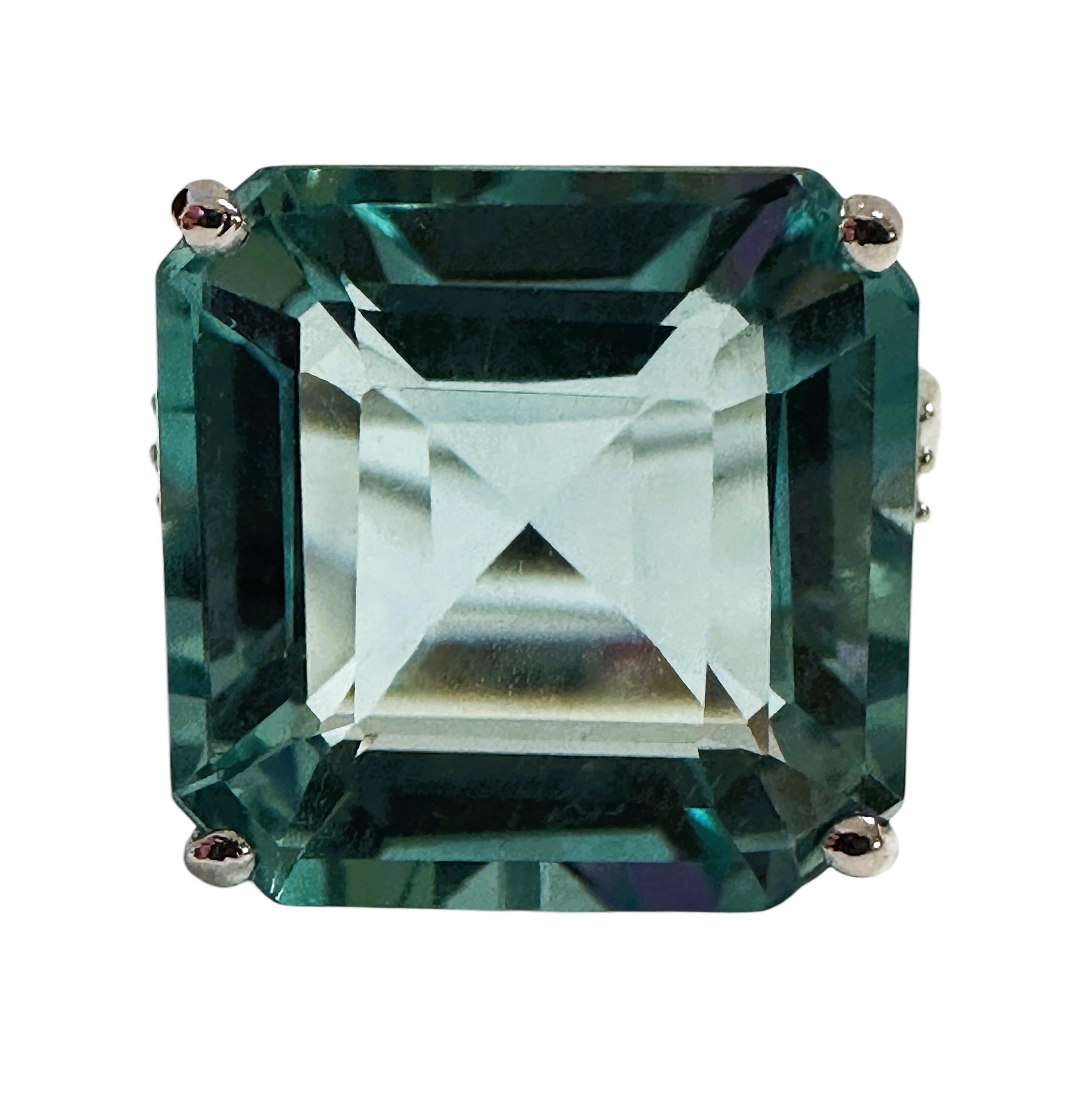 This ring is just stunning!   It is a size 6.25.  It has a beautiful asscher cut aquamarine center stone that is 11.0 cts.  The stone measures 14 x 14 mm and is flanked by diamond cut  white sapphire stones on either side.  The ring is sizeable at