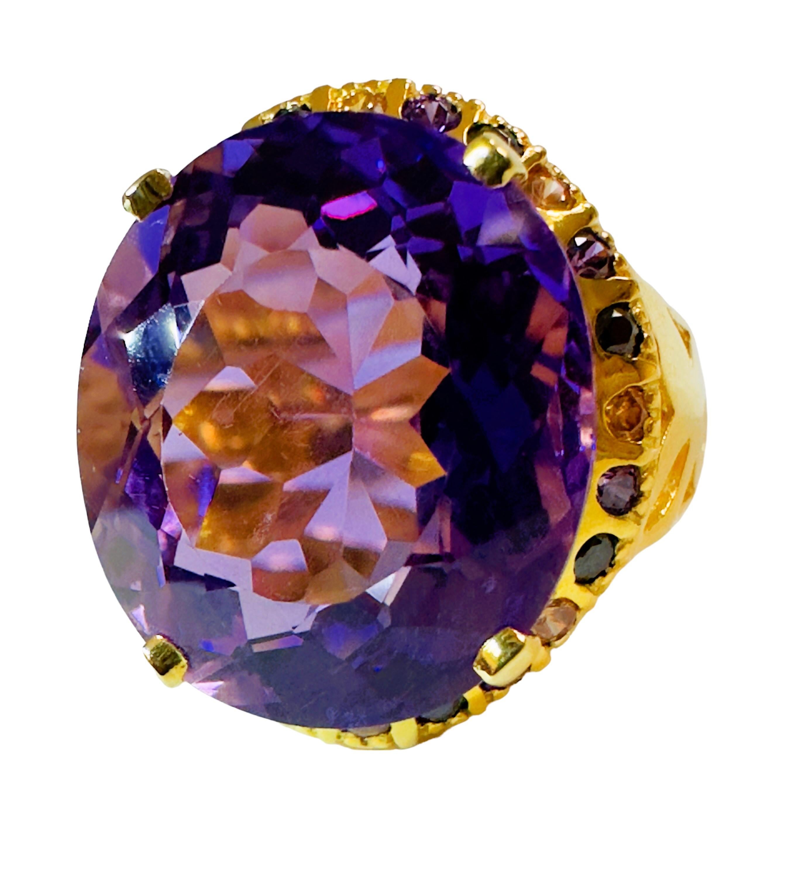 What beautiful colors in this ring!  The ring is a size 6.5.  The stone is from Brazil and is just exquisite.  It is a very high quality stone.   It is an Oval cut stone and is 13.2 Cts   The main stone is 17 x 14.7 mm and it is surrounded by
