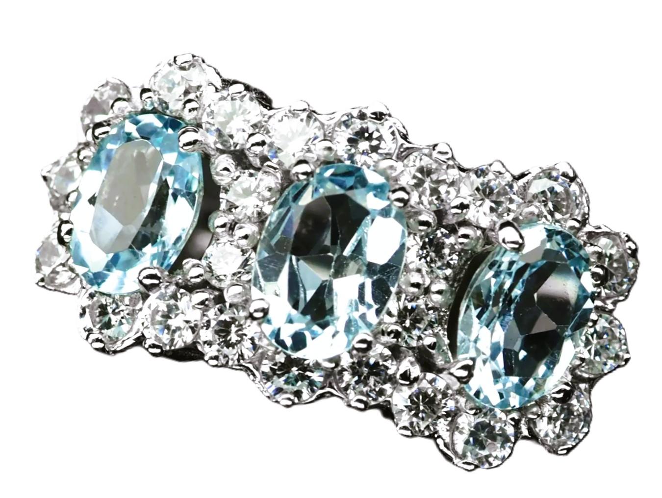 This ring is just stunning!   It is a size 7.5.  It has 3 light blue pastel sapphires that total 2.60 cts.  The 3 oval cut stones are 7 x 5 mm and are surrounded by diamond cut white sapphire stones.  The ring is sizeable at your local jeweler.  I