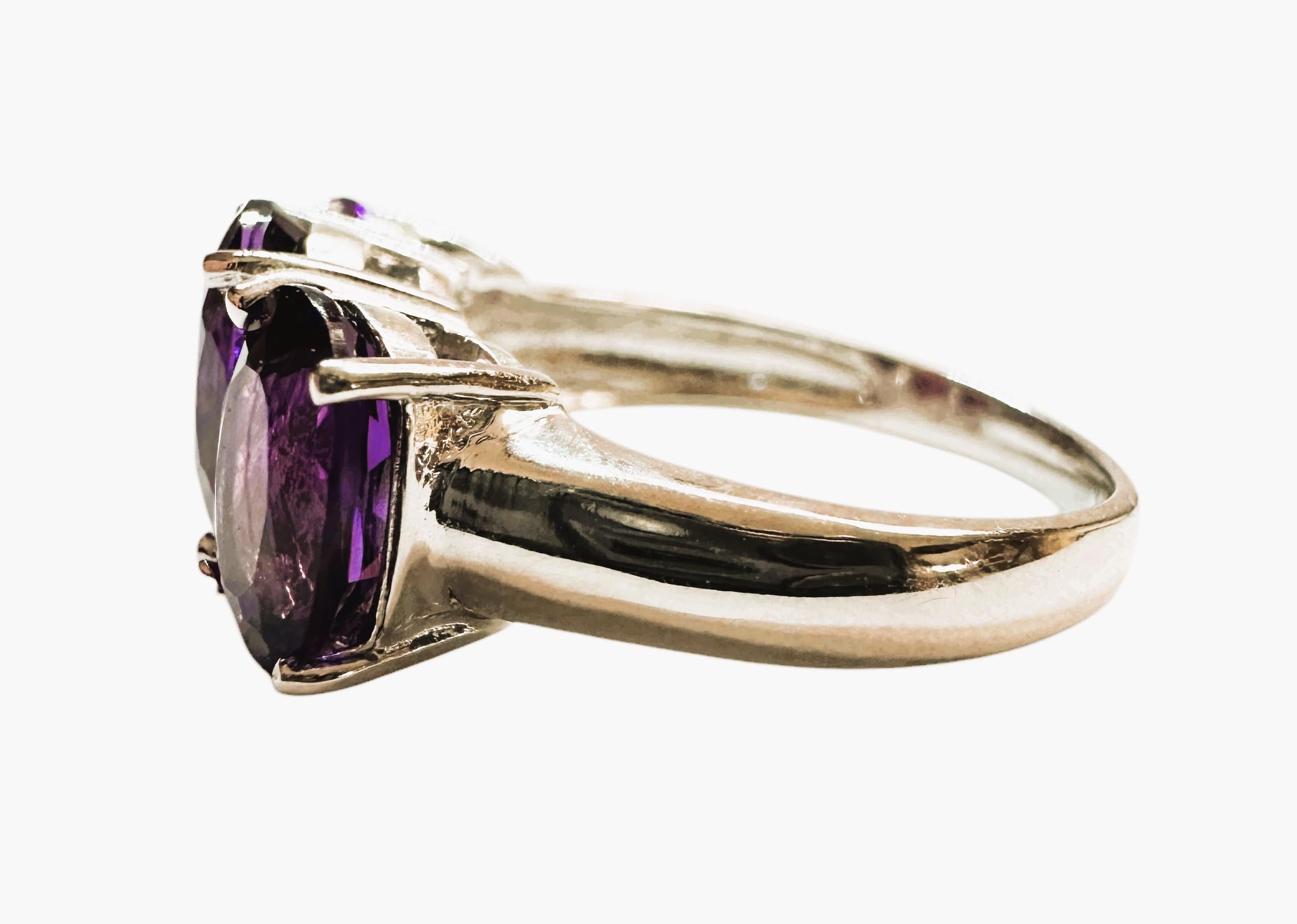 This ring is just gorgeous.  The photos don't do it justice so refer to the video to see the true beauty of the ring.  The ring is a size 6.5.   The Amethyst stones are from Brazil and are just exquisite. The stones are a fancy oval cut stones and