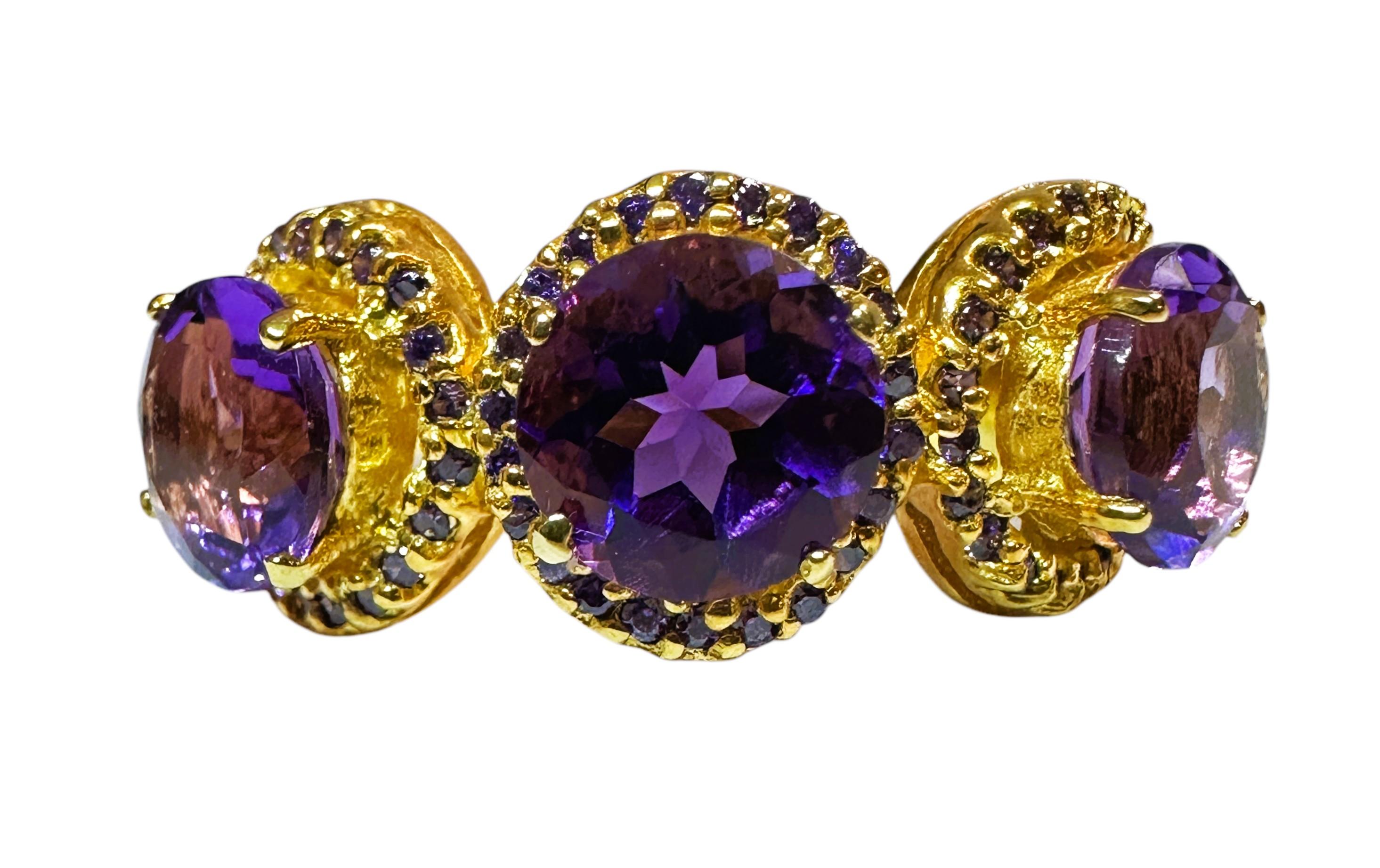 This ring is just gorgeous.  The photos don't do it justice so refer to the video to see the true beauty of the ring.  The ring is a size 6.5.   The Amethyst stones are from Brazil and are just exquisite. The 3 stones are faceted round cut stones