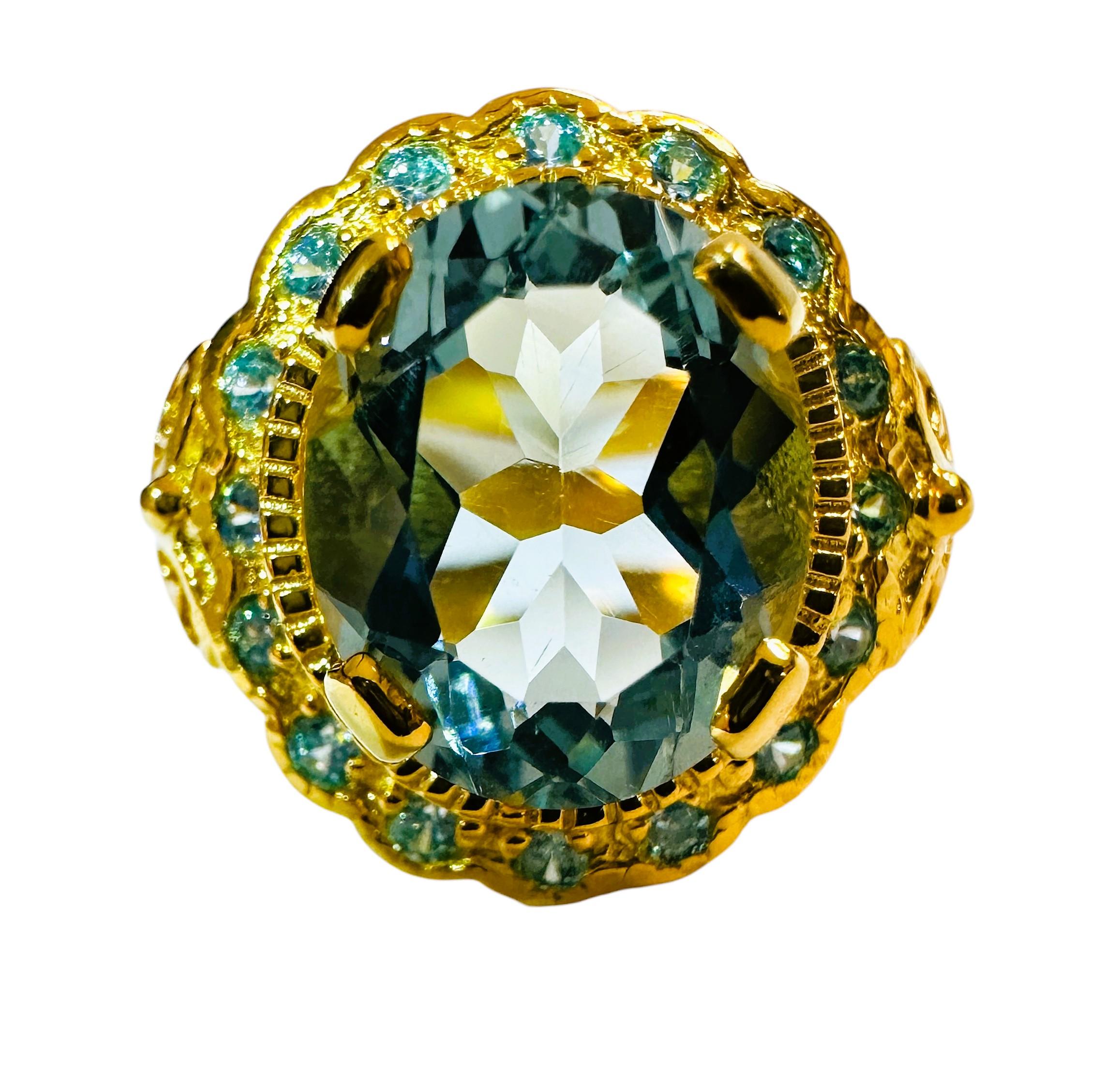 The stone is from Brazil and is just exquisite. The stone is a sea blue aquamarine and is 3.20 cts.  The stone is an oval cut stone and measures 11 x 9 mm and is surrounded by diamond cut blue sapphires which really compliments the ring  It is