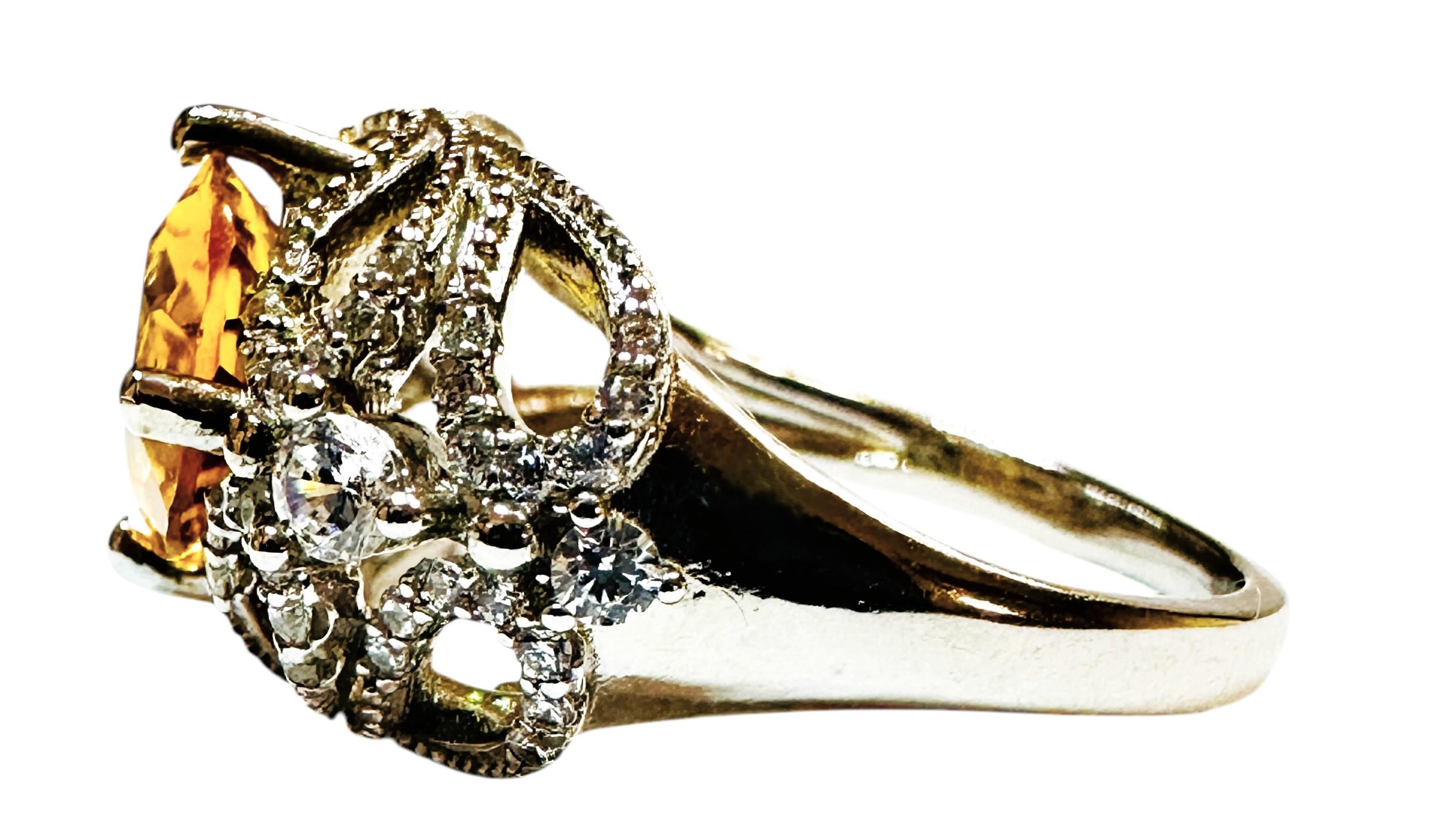 What a gorgeous ring!  The ring is a size 7.  The stone is from Brazil.  A very high quality stone.   It is a fancy oval cut stone and is 3.60 Cts.   The main stone is 11.2 x 9.2 mm.  It is surrounded by Diamond Cut White Sapphires on the beautiful