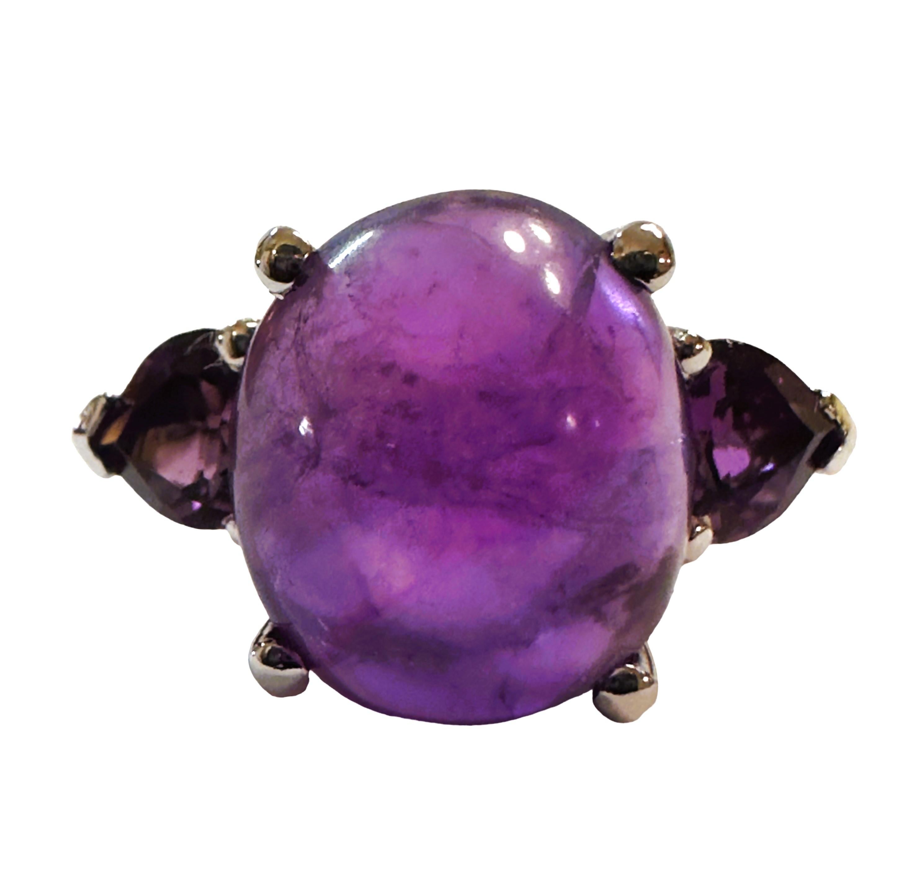 What beautiful colors in this ring!  The ring is a size 7.  It is from Brazil and is just exquisite.  It is a highly rated stone.  It is an oval cut cabochon stone and is 7.3 Cts   The main stone is 12.3 x 10.5 mm and it is flanked by 2 beautiful