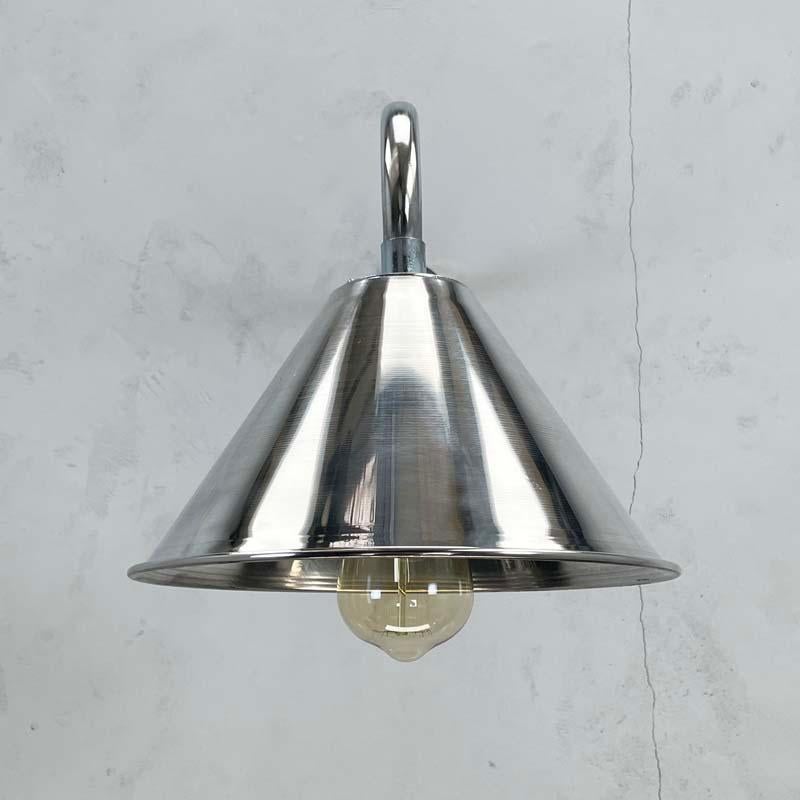 A British cantilever wall lamp made from galvanised steel tube and a spun and mirror polished conical shade.

Reach of the cantilever can be specified and also the shade colour can be re-finished on request by RAL or Pantone