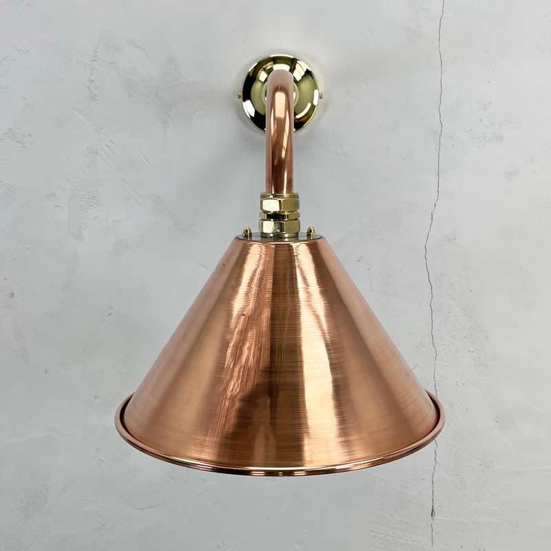 A British cantilever wall lamp made from copper tube and a spun and mirror polished copper conical shade.

Reach of the cantilever can be specified and also the shade colour can be re-finished on request by RAL or Pantone