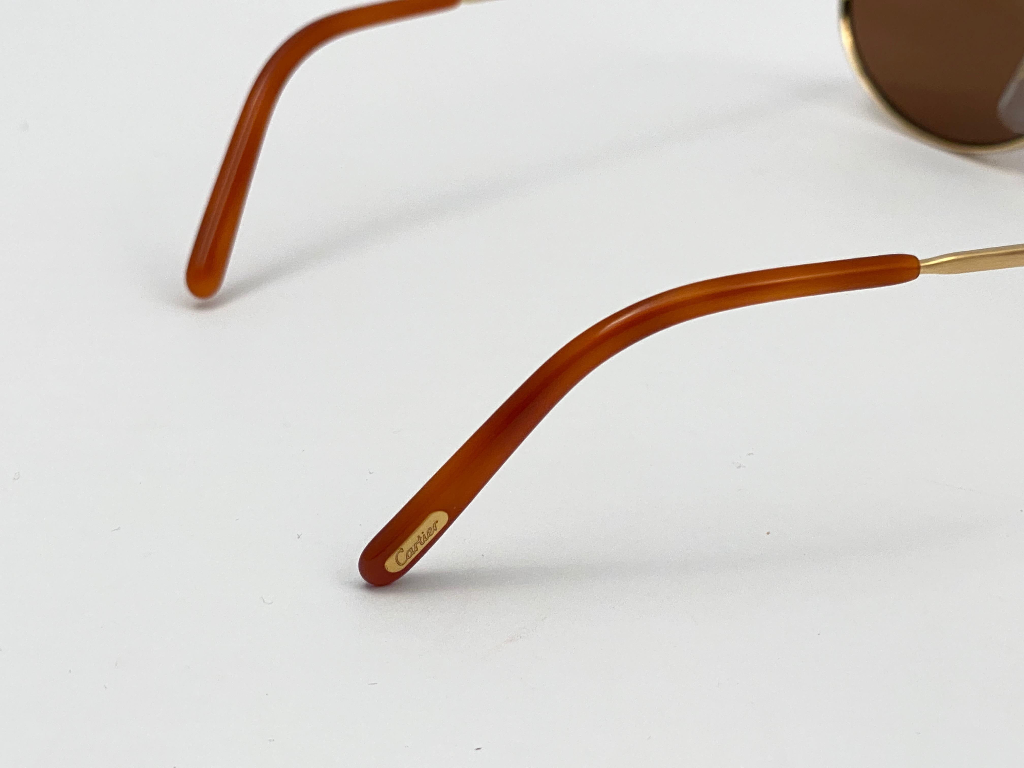 Beige Cartier, lunettes de soleil Spider de 48 mm en plaqué or brossé, France