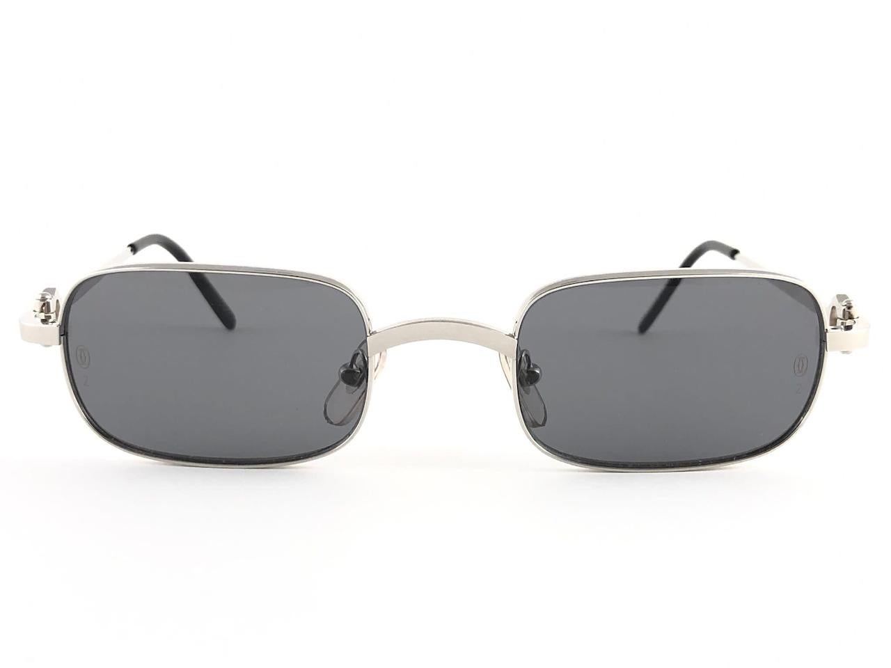 New Cartier Temper  platine plated with dark grey  (uv protection) lenses. 
 All hallmarks. Cartier silver signs on the earpaddles. These are like a pair of jewels on your nose with the 18k platine plated accents. Beautiful design and a real sign of