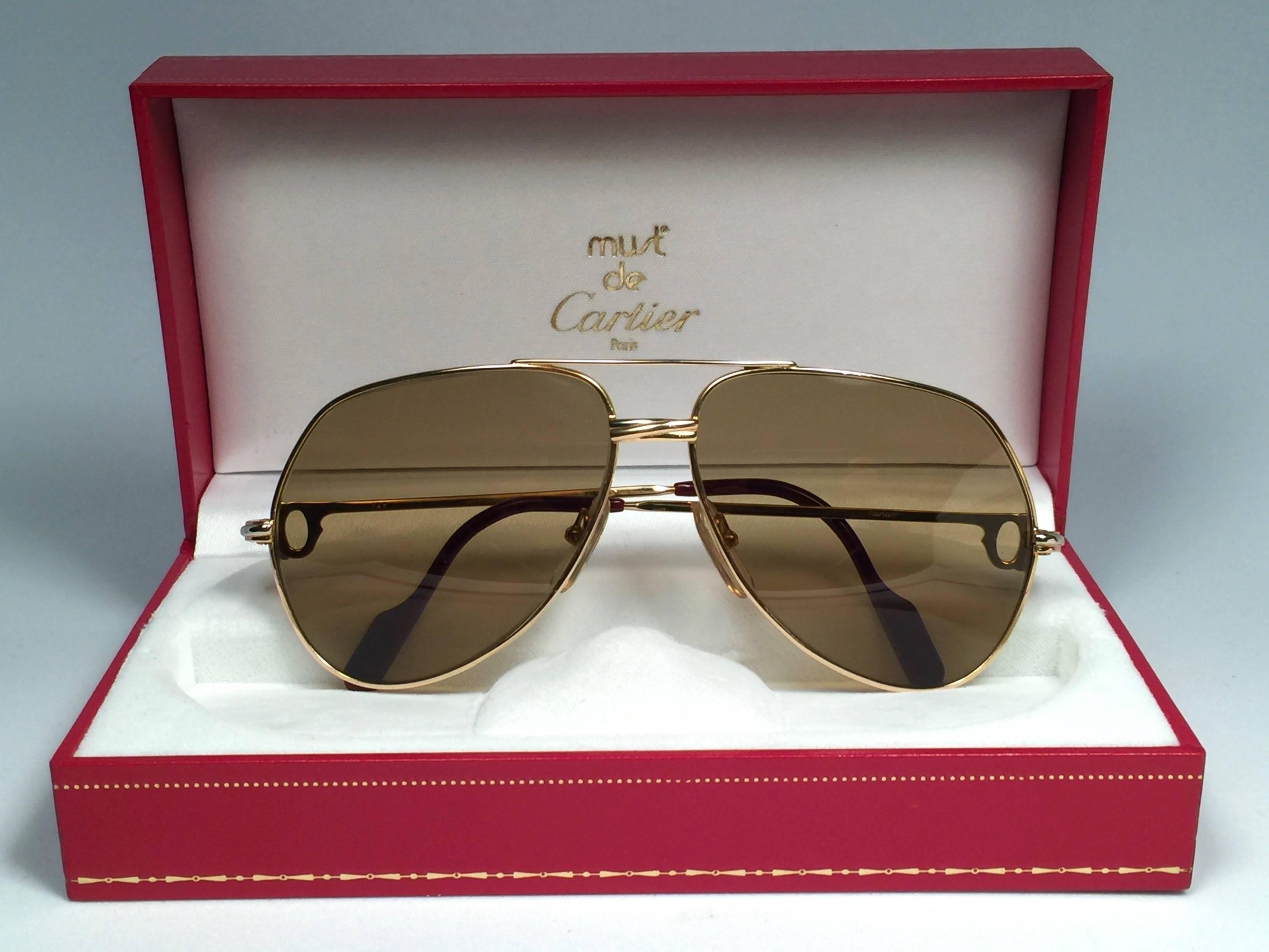 New and ultra rare, collector item Cartier Aviator Vendome 59MM 18K 750 GOLD FILLED sunglasses with Cartier brown changeable Lenses.  
Frame is with the famous Vendome stripes on the front and sides in yellow and white gold. 
All hallmarks. 
Red