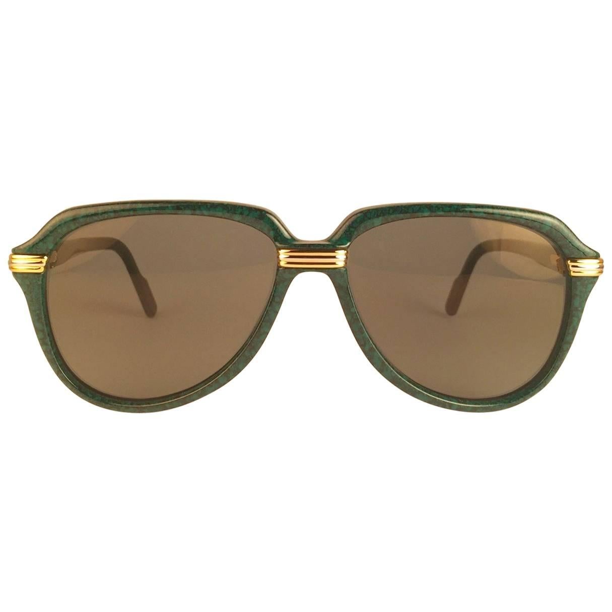 New Collectors Item. 
Unique and Rare Prototype Cartier Aviator Vitesse sunglasses, the Marbled Green Edition with yellow and white gold accents.
Frame is with the sides in gold and white hard plated gold. All hallmarks. Cartier gold signs on the