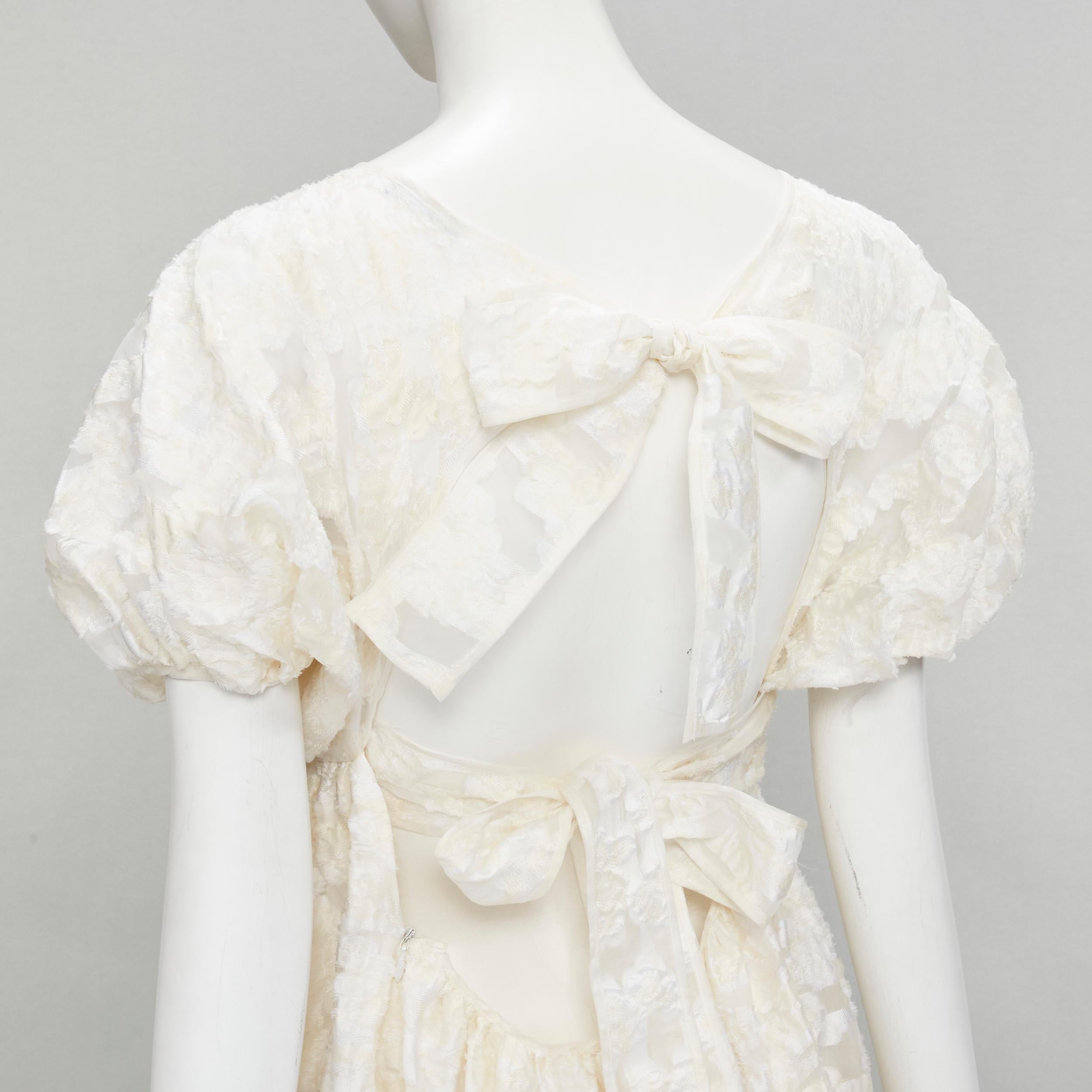 new CECILIE BAHNSEN white floral fil-coupe organza flared bridal dress UK6 XS
Brand: Cecilie Bahnsen
Material: Polyester
Color: Beige
Pattern: Floral
Extra Detail: Cross tie straps. Side zip closure.

CONDITION:
Condition: New with tags. 
Comes