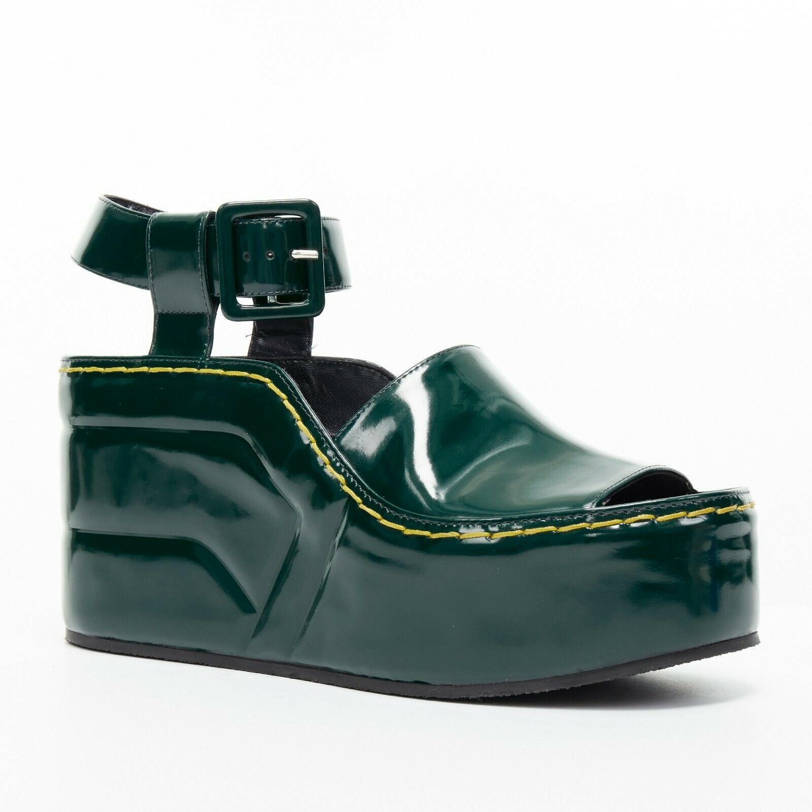new CELINE AW14 runway dark green polished leather Doc Marten platform EU40
CELINE BY PHOEBE PHILO
FROM THE FALL WINTER 2014 COLLECTION
Forest green polished leather upper. 
Doc Marten inspired. 
Yellow contrast thick stitching along outsole. 
Thick