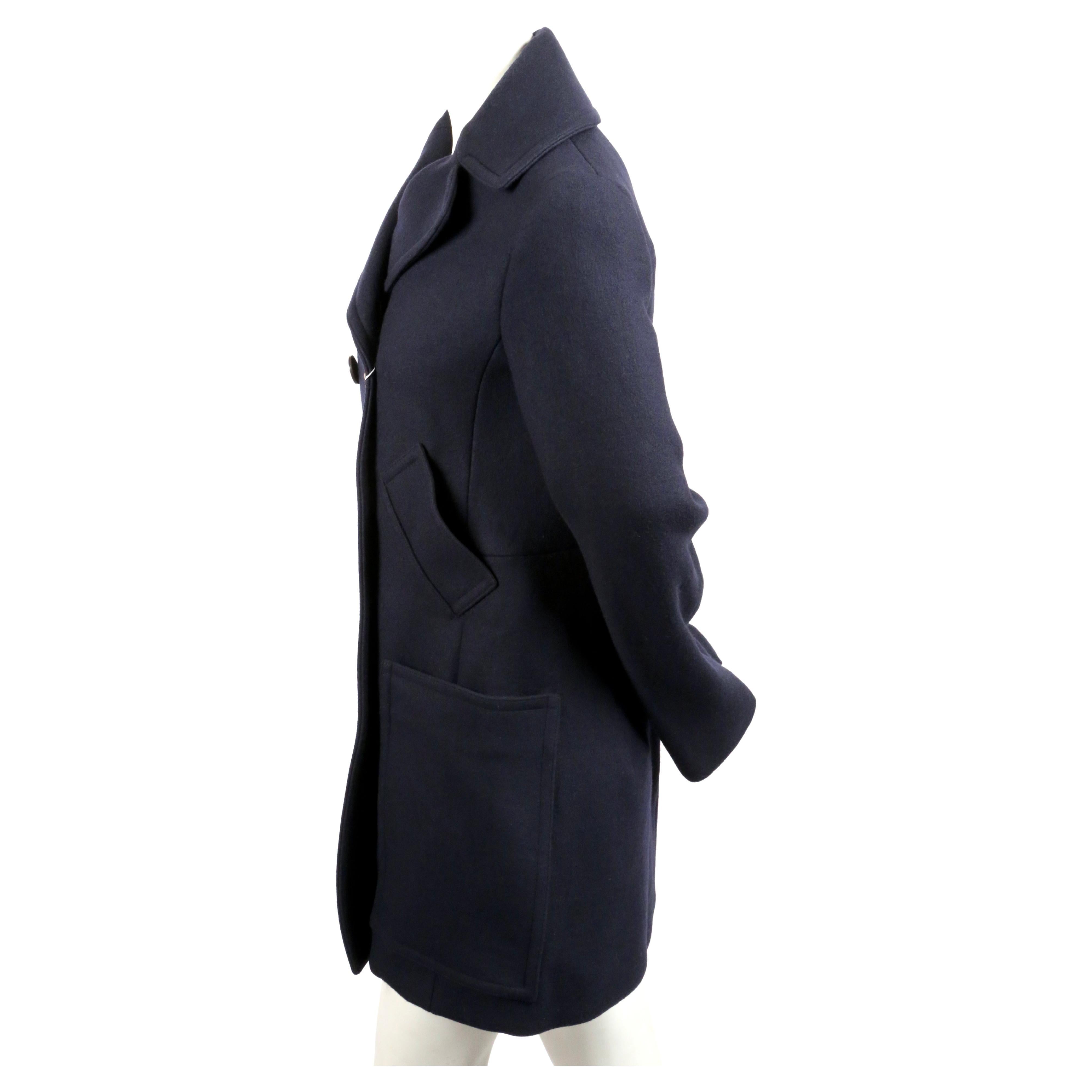 Deep navy-blue wool peacoat with large wrap-around patch pockets and single gold button detail designed by Phoebe Philo for Celine. French size 40 although this runs small and best fits a US 4-6. Approximate measurements: shoulder 16