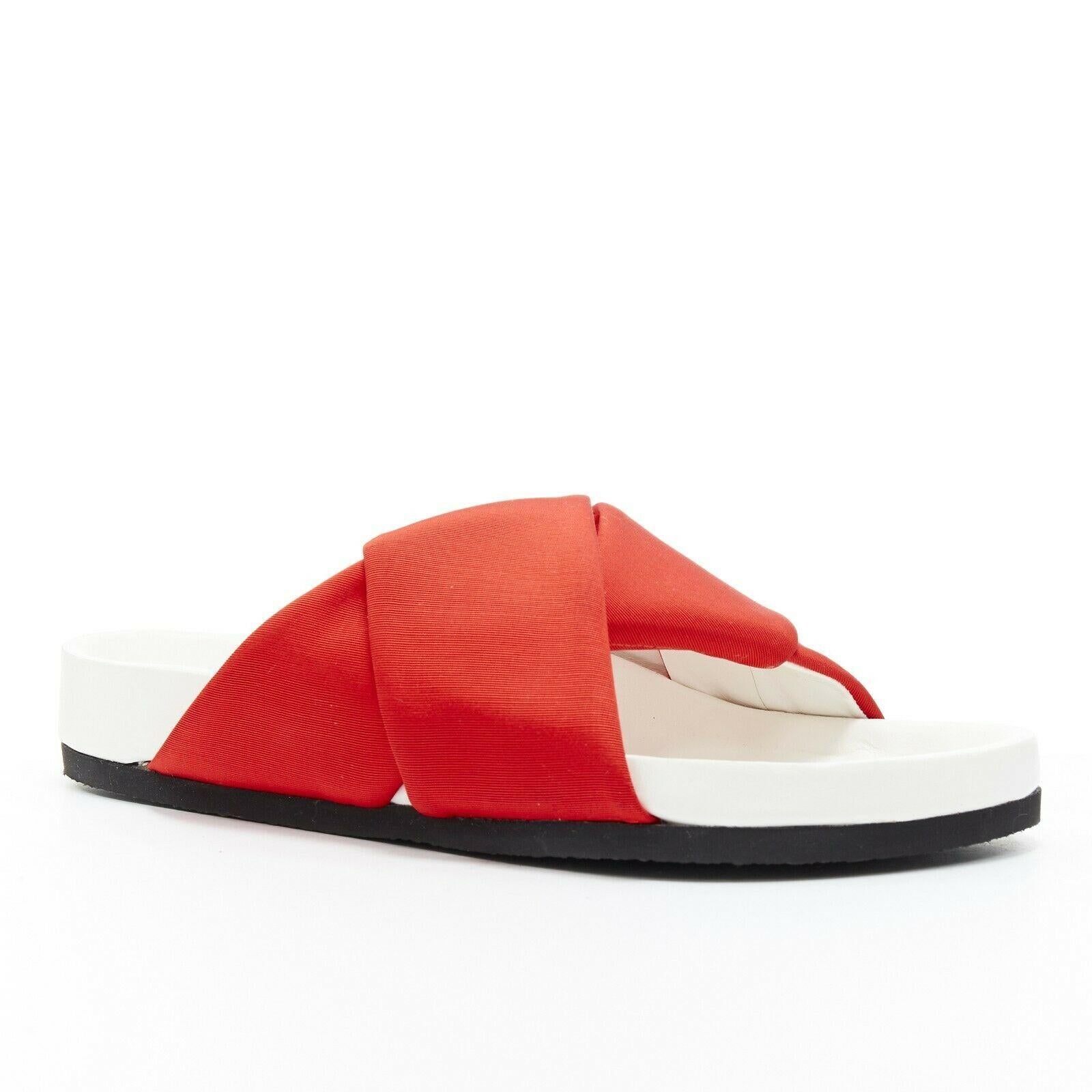 new CELINE PHOEBE PHILO Twist red grosgrain strap white sole slide sandals EU37

CELINE BY PHOEBE PHILO
Boxy slides. Red grosgrain origami twisted strap upper. 
White leather sole. Black rubber sole. Moulded footbed. 
Made in Italy.

SIZING
Designer