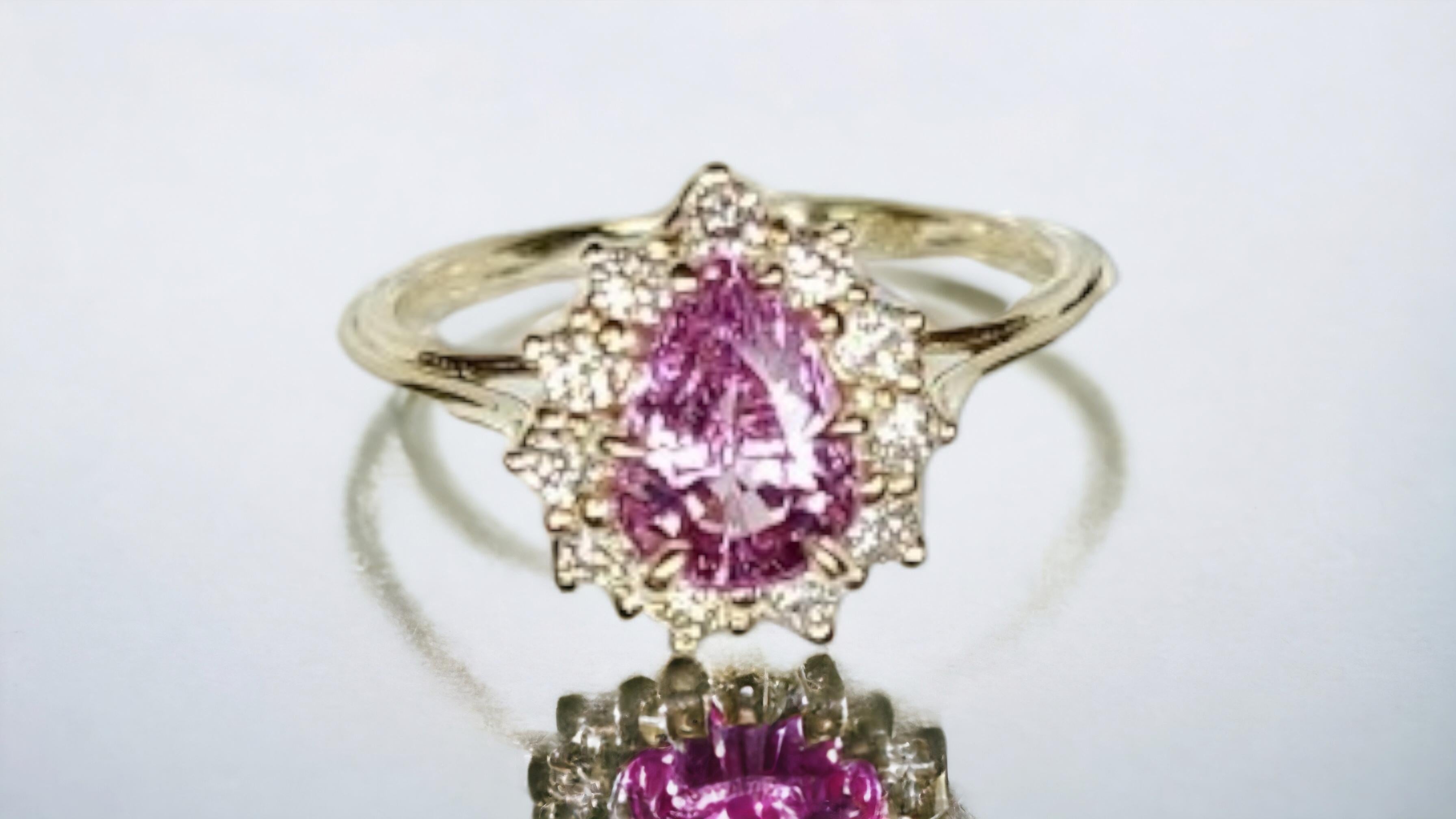 This beautiful ring from Lafrancee features a stunning natural unheated 1.37 CT. PERFECTLY CLEAN hot pink sapphire and surrounded by .28 ct ideal cut hearts and arrows sparkling diamonds set in 14K yellow gold. The pear-shaped sapphire is natural,
