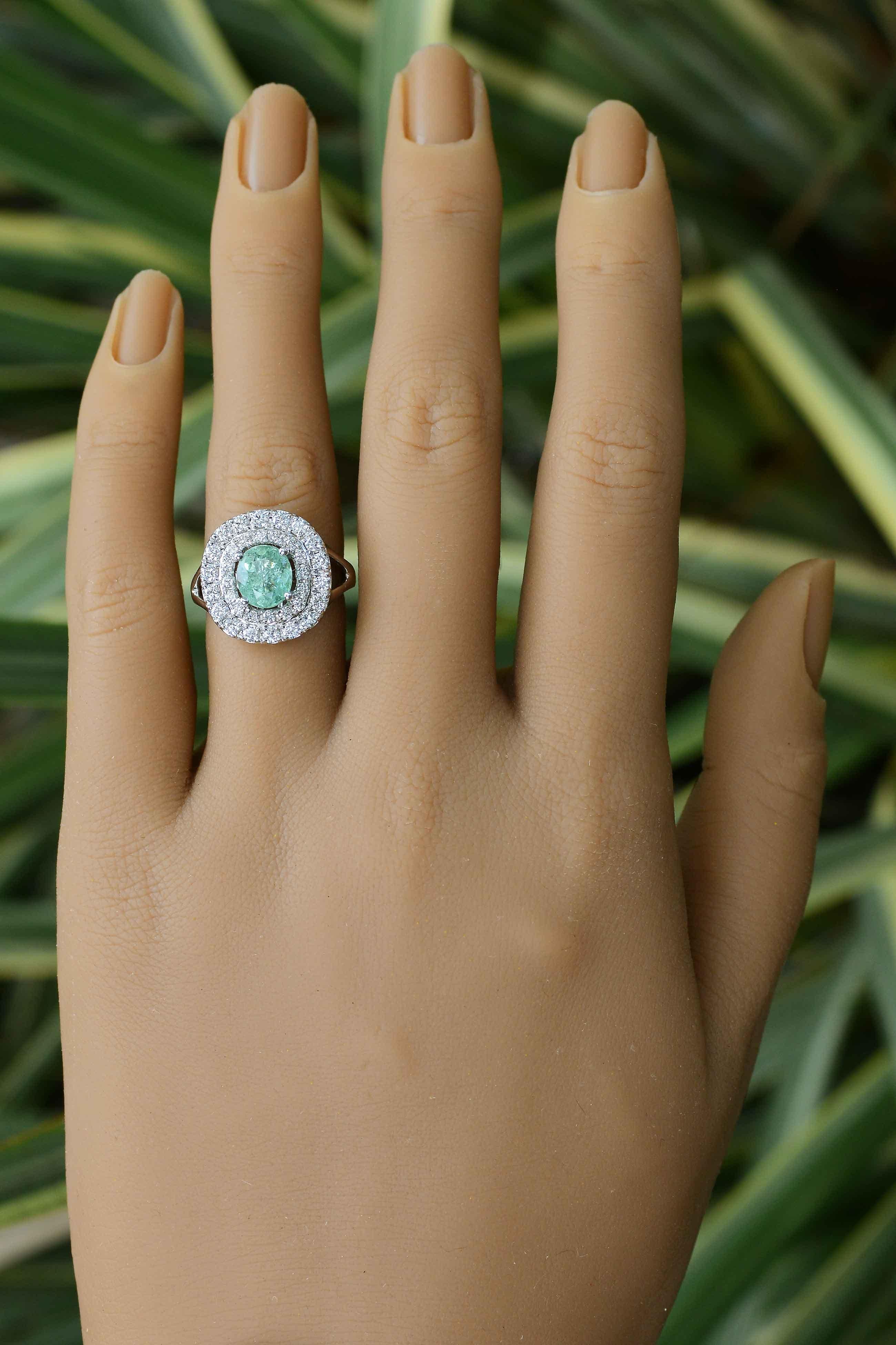 The Princeton Paraiba tourmaline engagement ring with a dazzling, double diamond halo makes for an astonishing gemstone bridal treasure or cocktail ring. The central gem is certified by the Gemological Institute Laboratories as natural Paraiba and