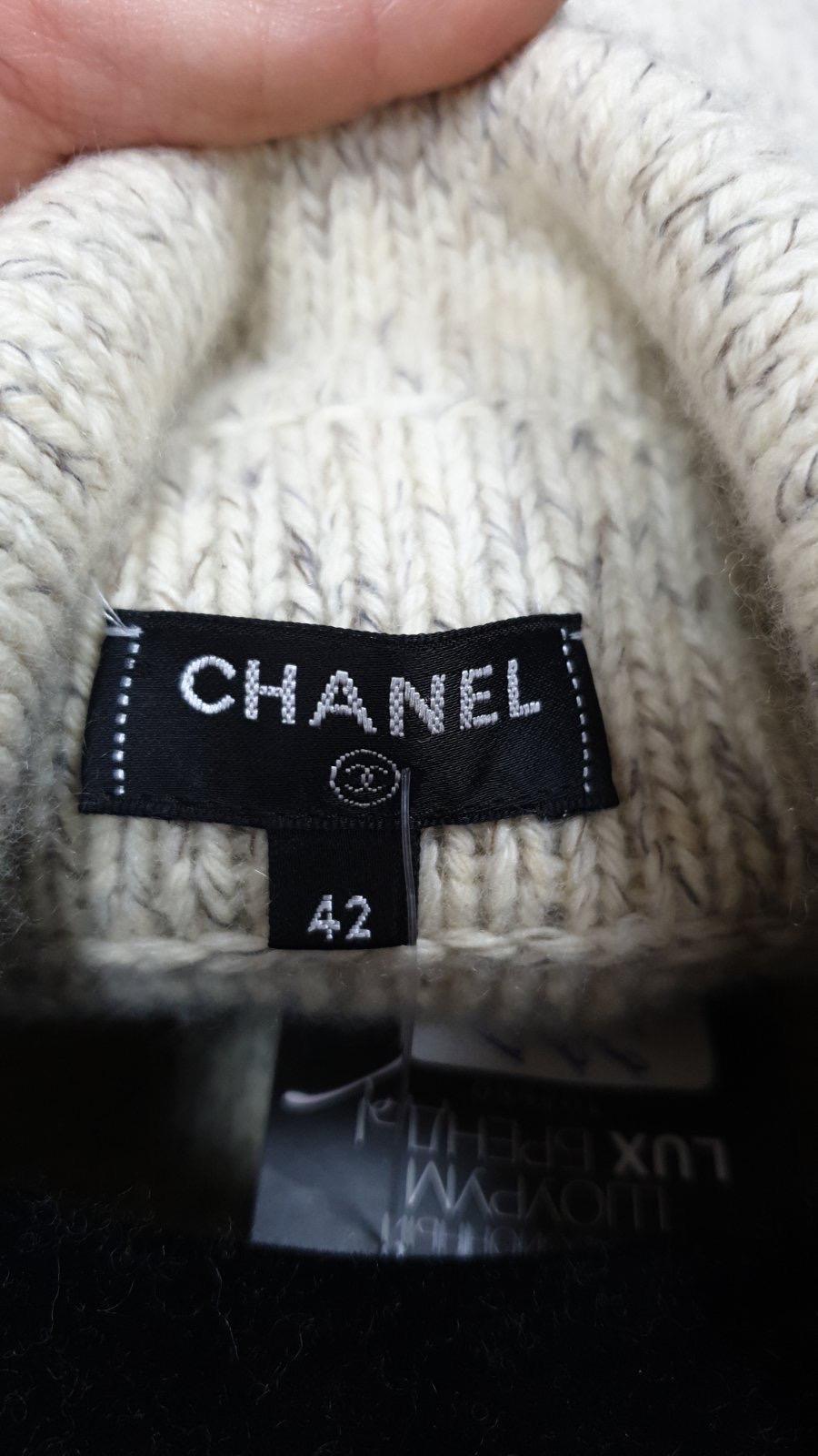 Chanel cashmere-blend sweater coat with CC logo buttons.
 It is adorned with a front button closure and 2 front pockets. 
This is new, never worn.

Sz.42 (runs smaller)
Hanger is not included