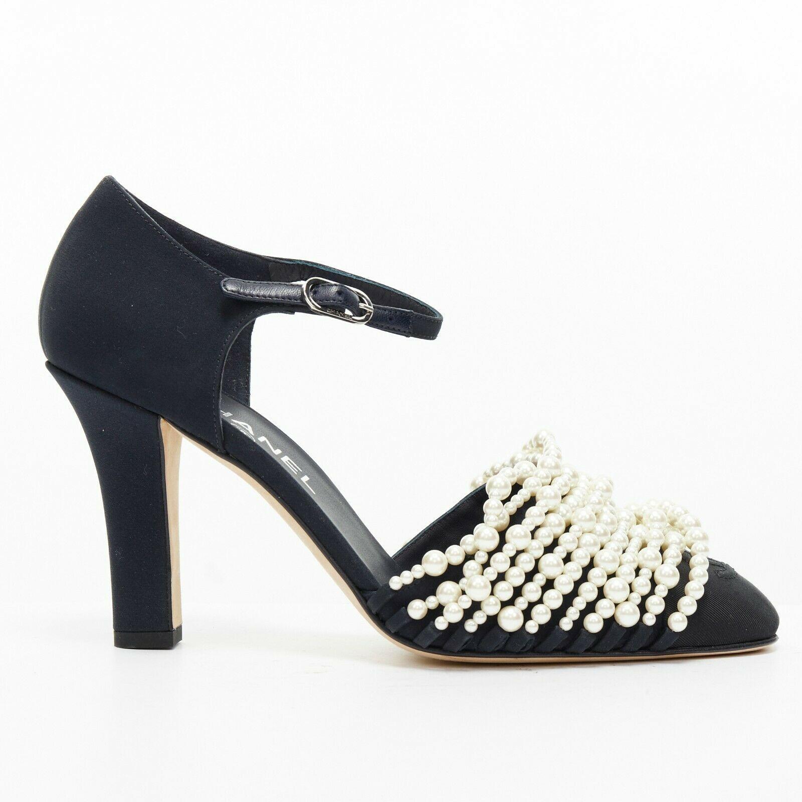 new CHANEL 17A navy multi pearl embellished CC satin toe ankle strap heels EU39

CHANEL
FROM THE FALL WINTER 2017 COLLECTION
Navy blue. Satin covered heel. Chunky heel. Ankle strap closure. 
Silver-tone Chanel signed buckle. White faux pearl strand
