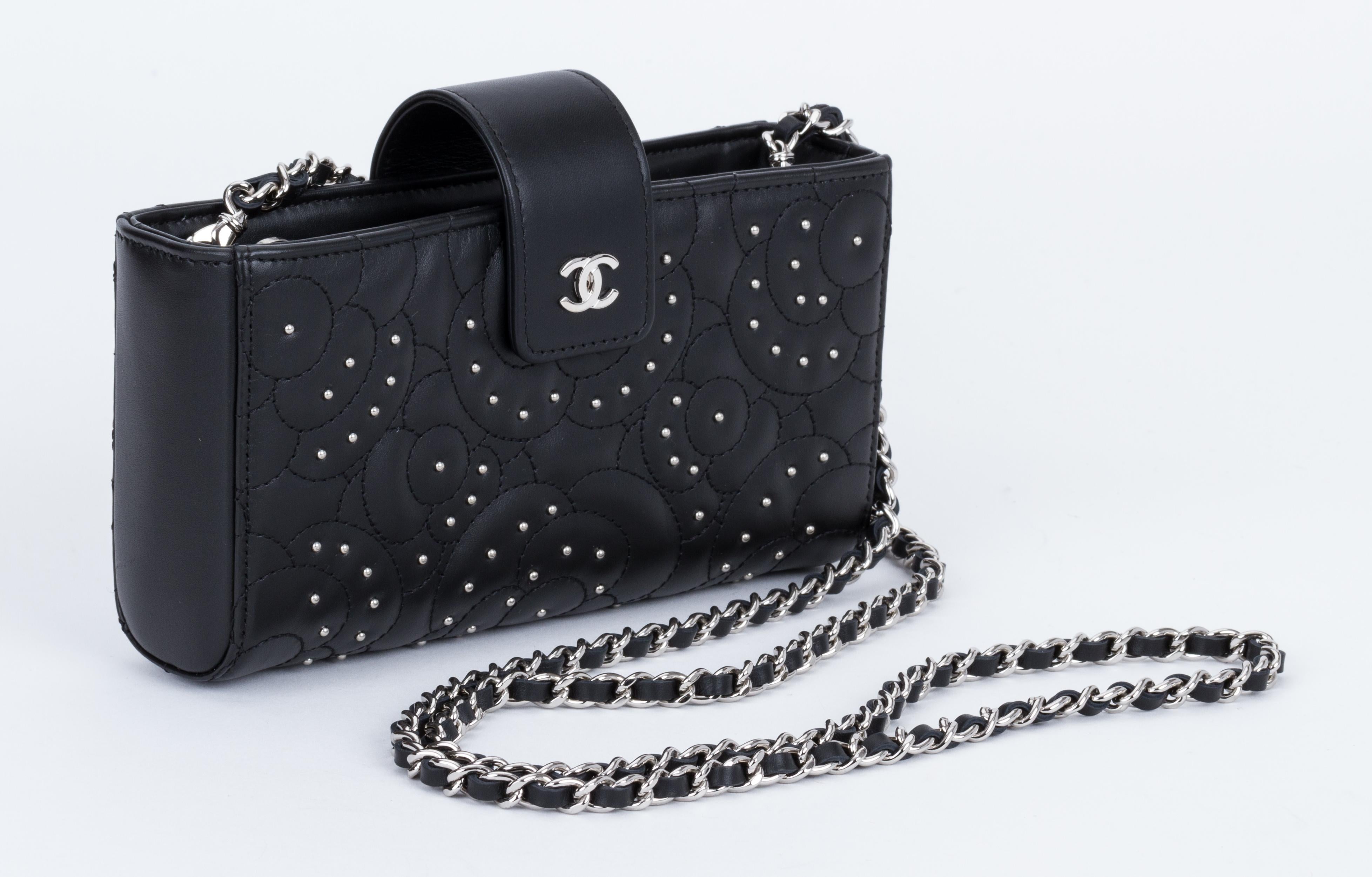 New in box, Chanel black lambskin camellia studs cross body bag. One zipped center compartment and two side open pockets. Detachable strap, shoulder drop 24