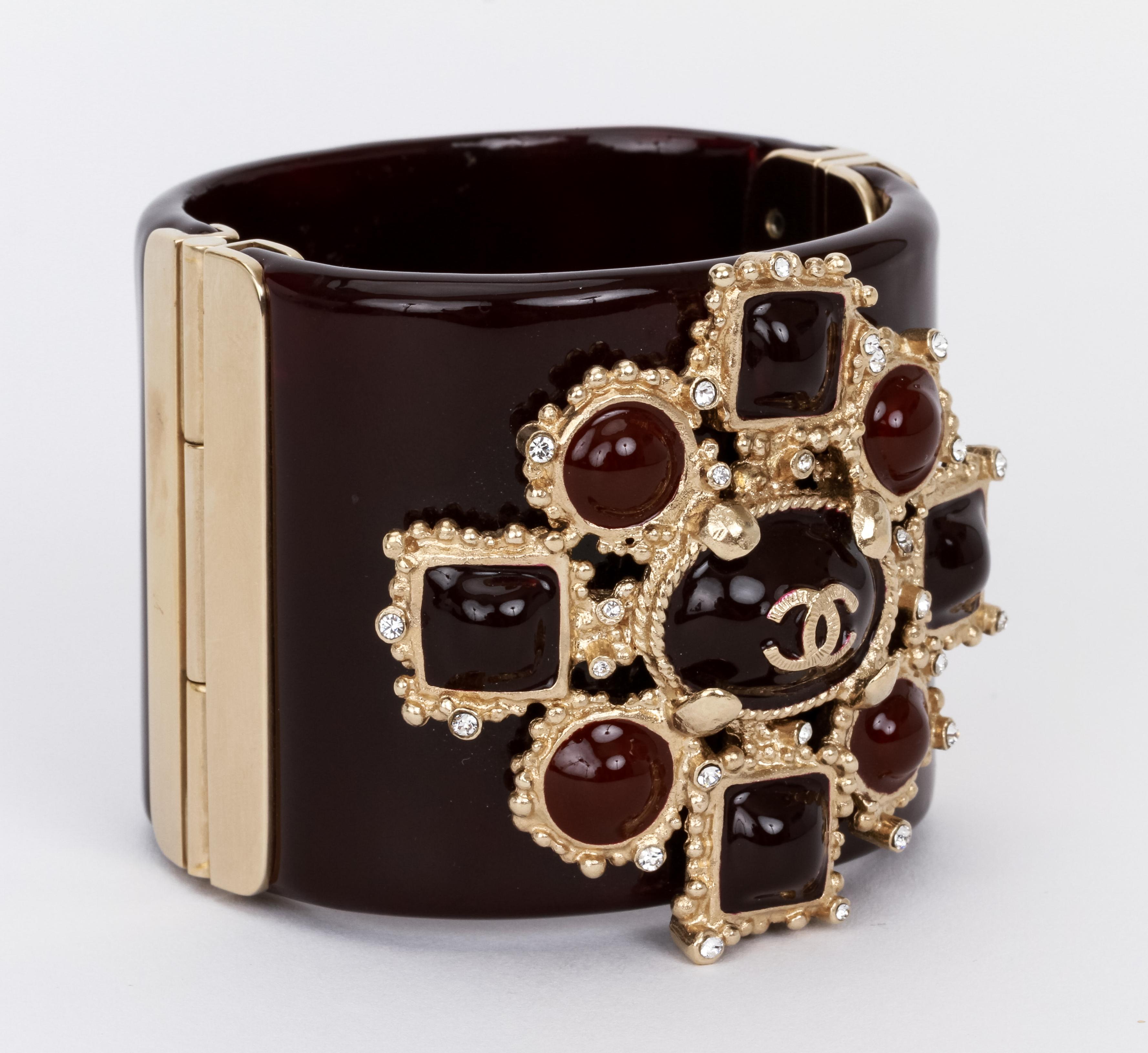 Chanel large cuff maltese cross with gripoix. The epitome of chic in maroon, brown, and burgundy tones. Original pouch and box.