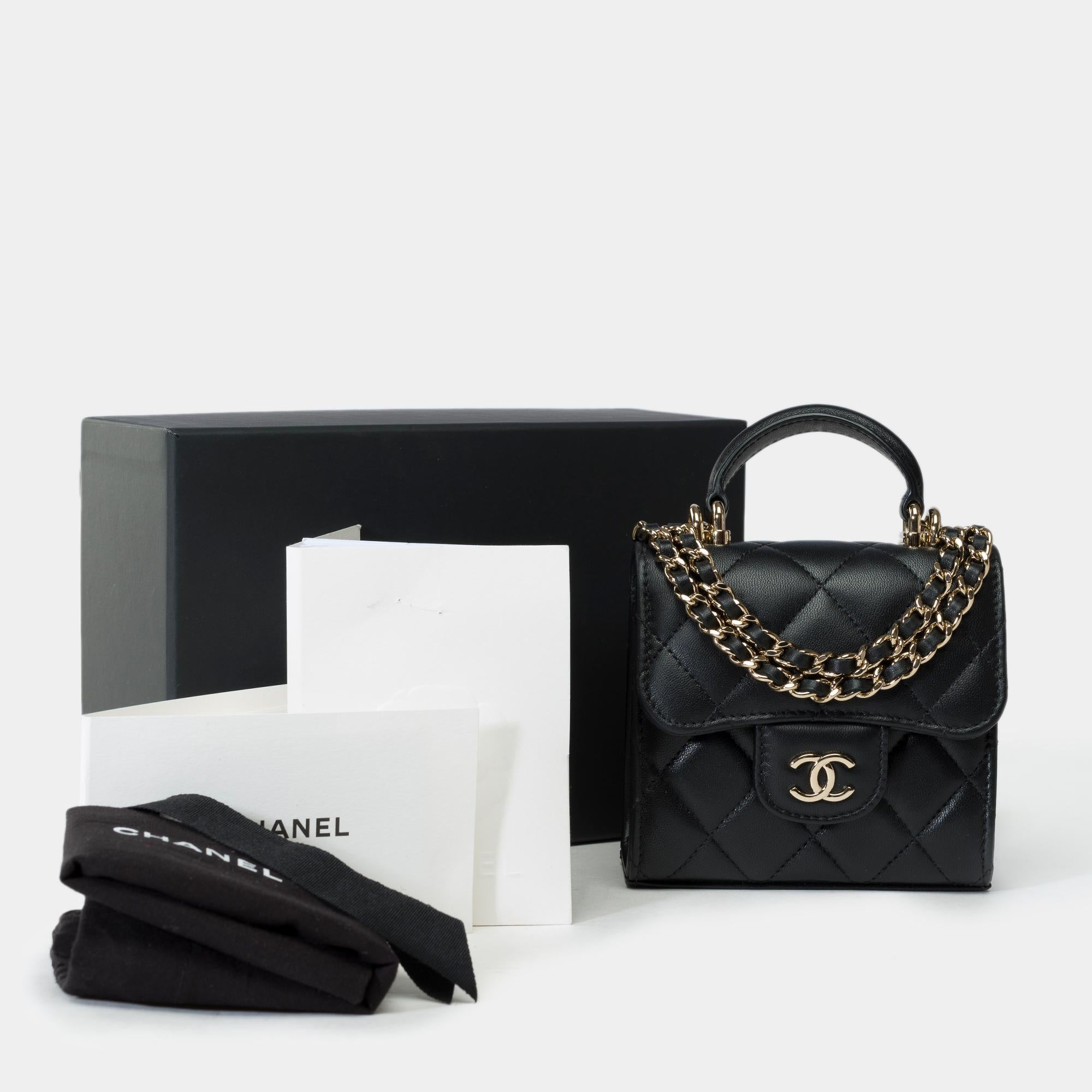 Exceptional​ ​and​ ​Rare​ ​Chanel​ ​Clutch​ ​shoulder​ ​flap​ ​bag​ ​in​ ​black​ ​quilted​ ​lambskin,​ ​champagne​ ​metal​ ​trim,​ ​black​ ​leather​ ​handle,​ ​and​ ​champagne​ ​metal​ ​strap​ ​intertwined​ ​with​ ​black​ ​leather​ ​for​ ​hand,​