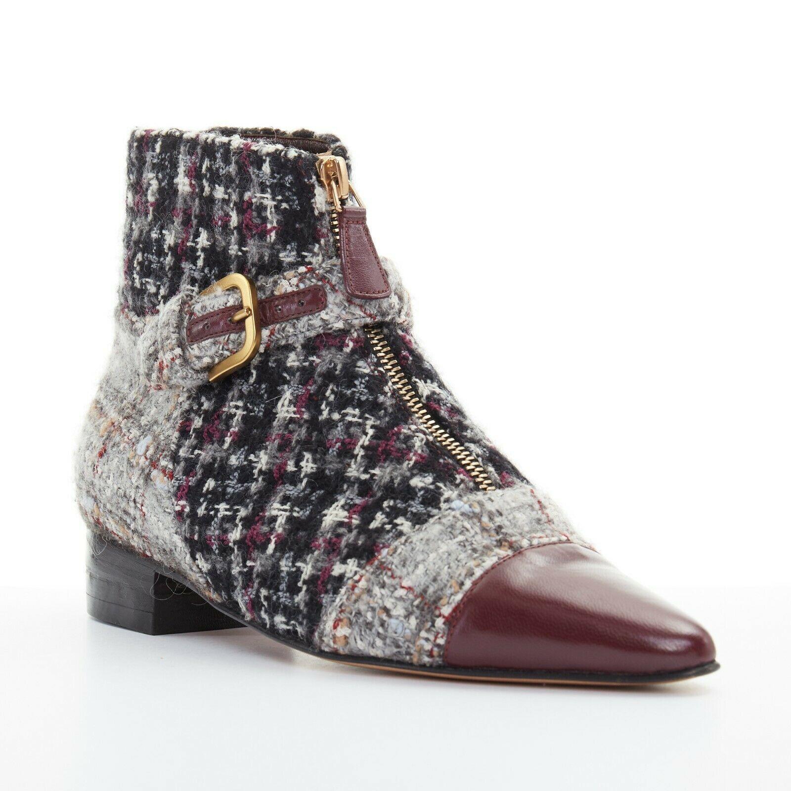 new CHANEL grey tweed red pointed toe cap zip buckle ankle bootie shoe EU35.5C
CHANEL
Mixed grey checked tweed upper. 
Maroon red leather toe cap. 
Rounded point toe. 
Gold-tone hardware zipped closure at front. 
Cross strap buckle detail at front.