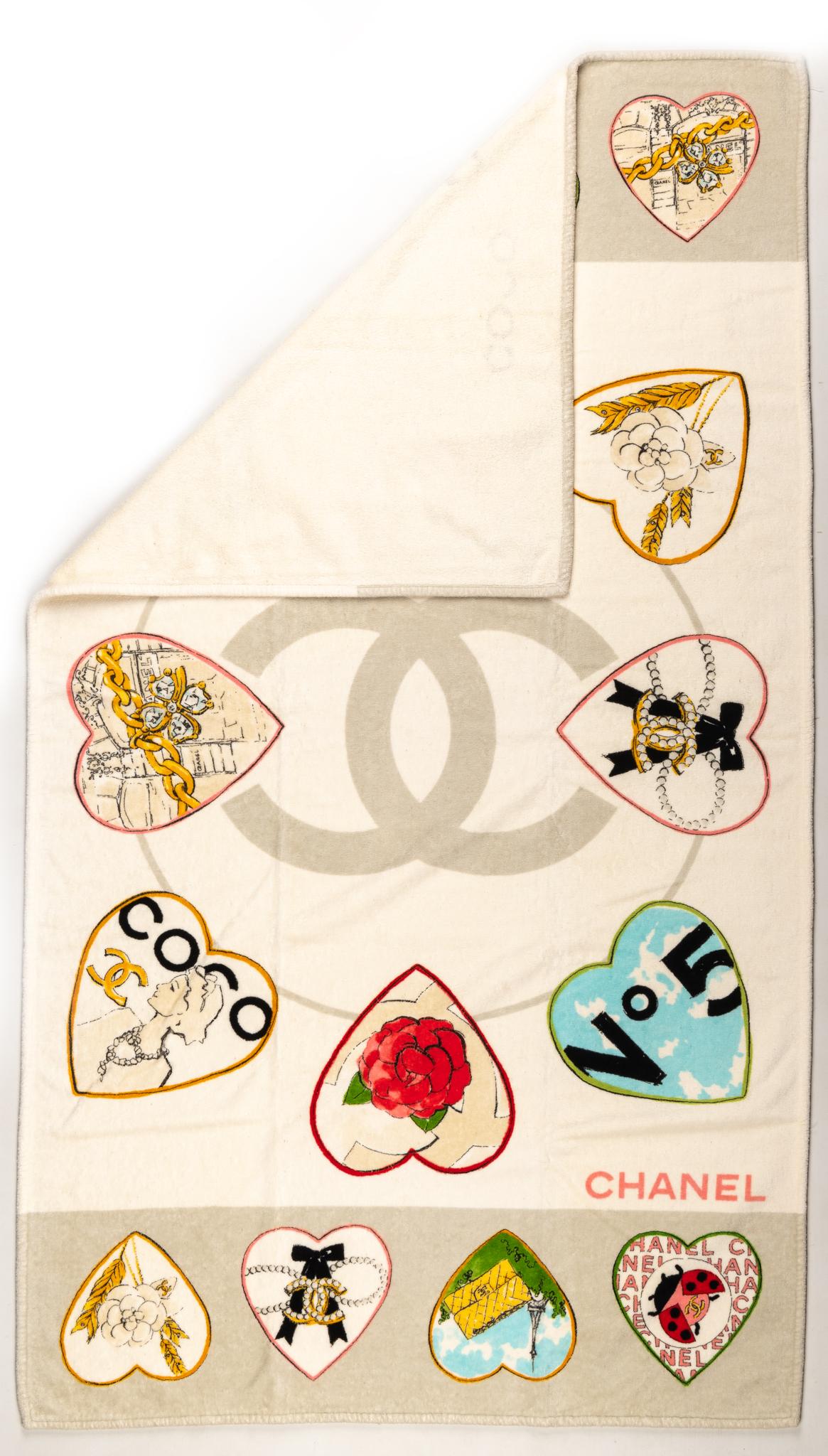 Chanel new beach towel in cream color base with colorful heart logo images.