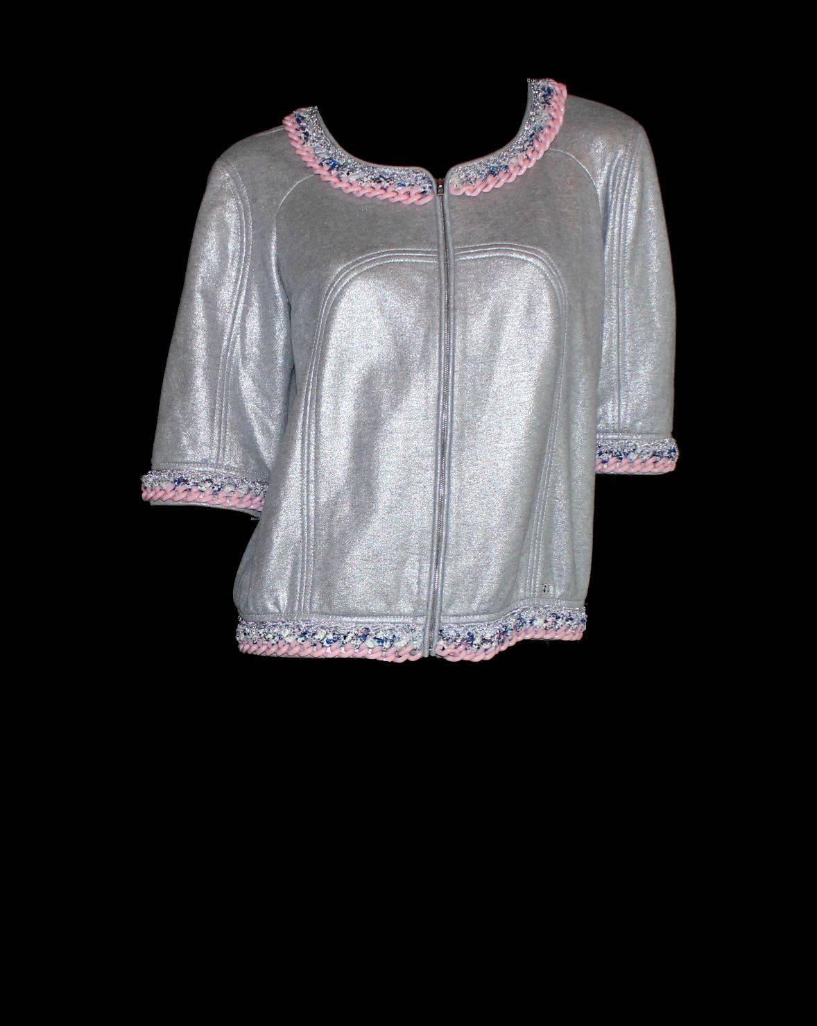 Amazing Chanel Jacket
A truly rare find
Shiny silver fabric
CC logo plate 
Two front pockets
Closes with CC logo zip
Pink chain detail
Tweed trimming
Perfect with jeans and white T-Shirt for a luxurious casual look
Size 40 
Retails for 6199$ plus
