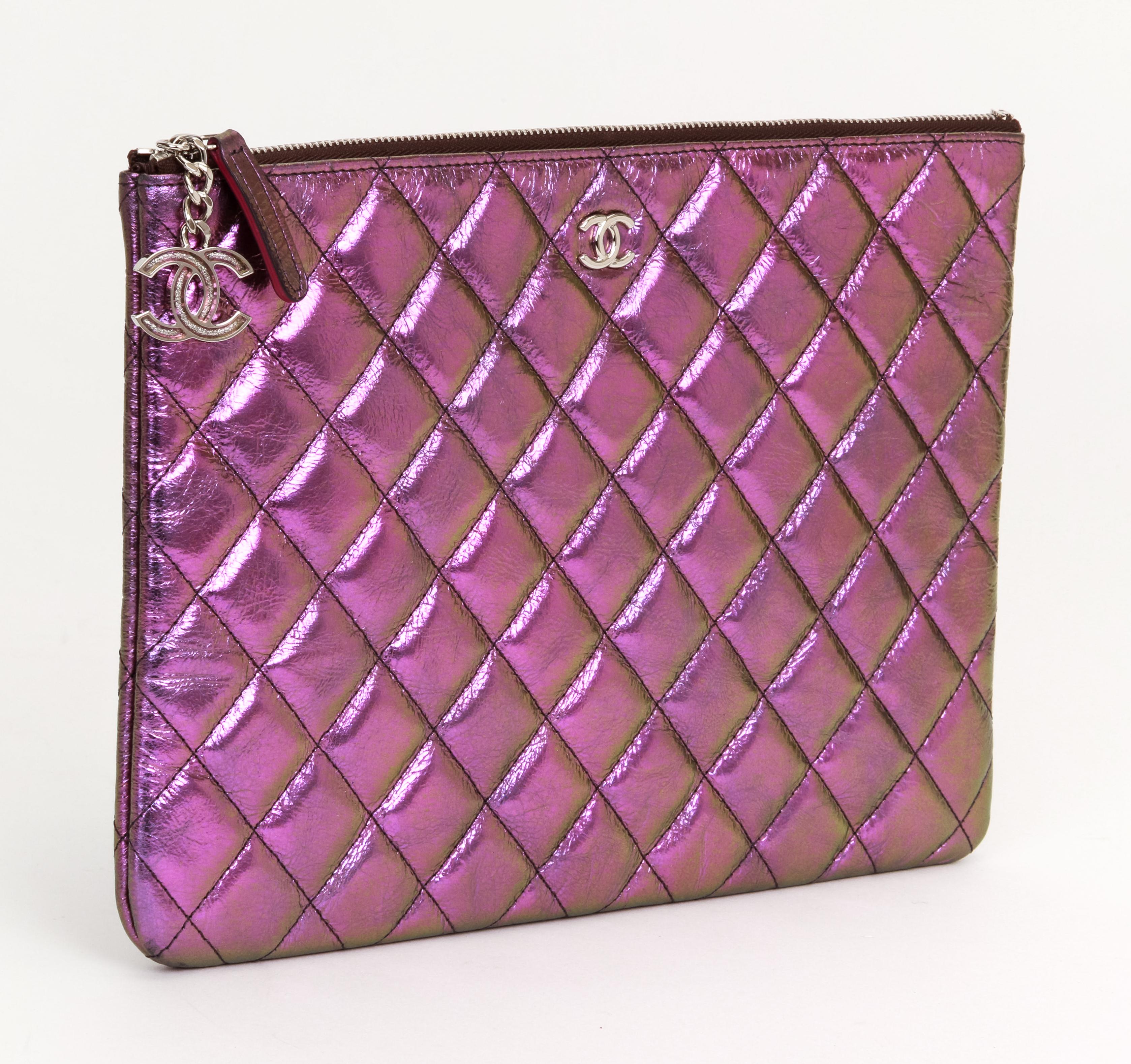 Chanel new purple iridescent quilted metallic clutch. Enamel shiny charm zipper pull. Collection 2019. Never worn, comes with hologram, id card and generic dust cover.