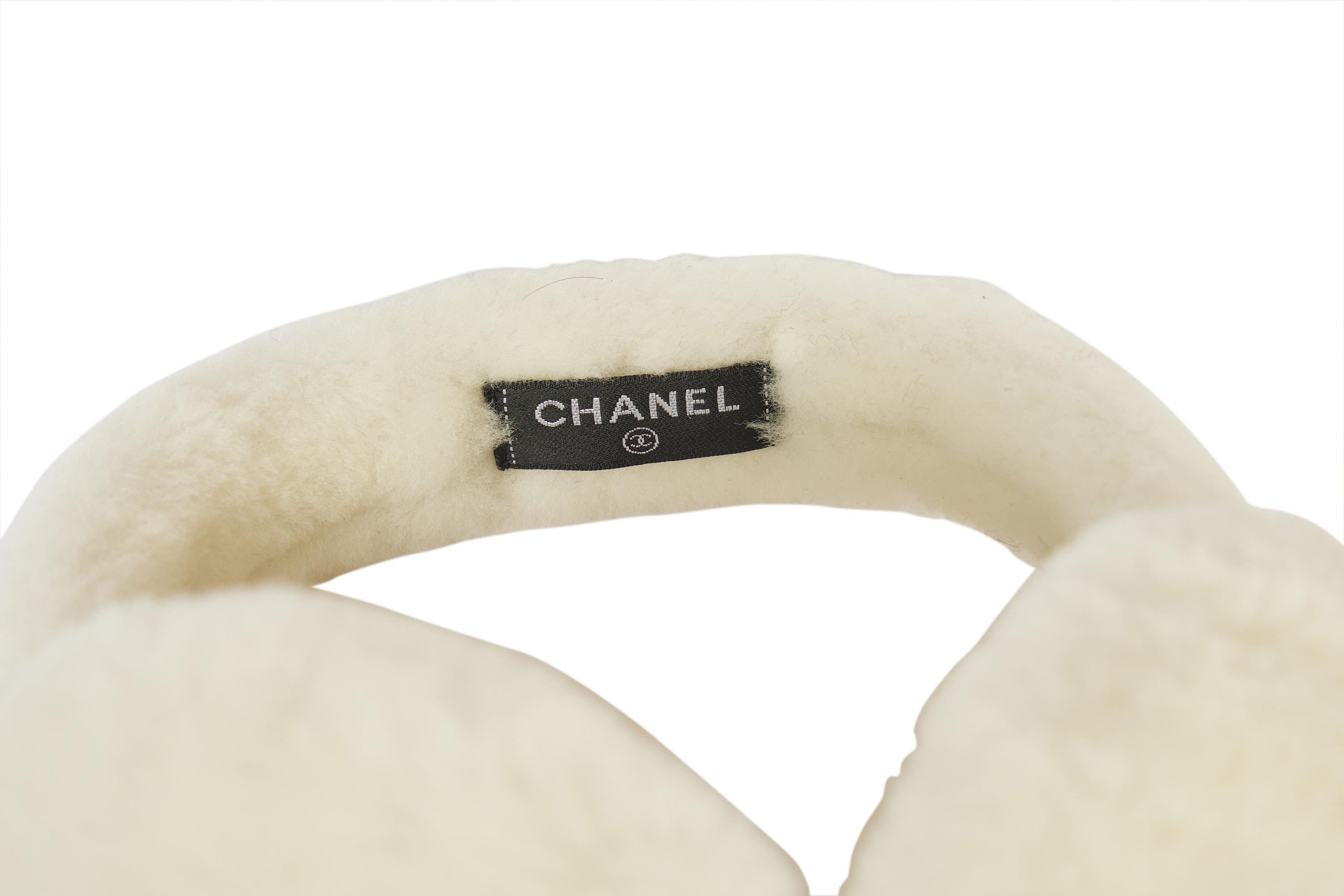 This super rare white Chanel ear muffs are sold out everywhere. They will keep you warm when you hit the slopes. This white piece has never been worn and comes in the original Chanel box. Both sides off the muffs show a big Chanel logo.