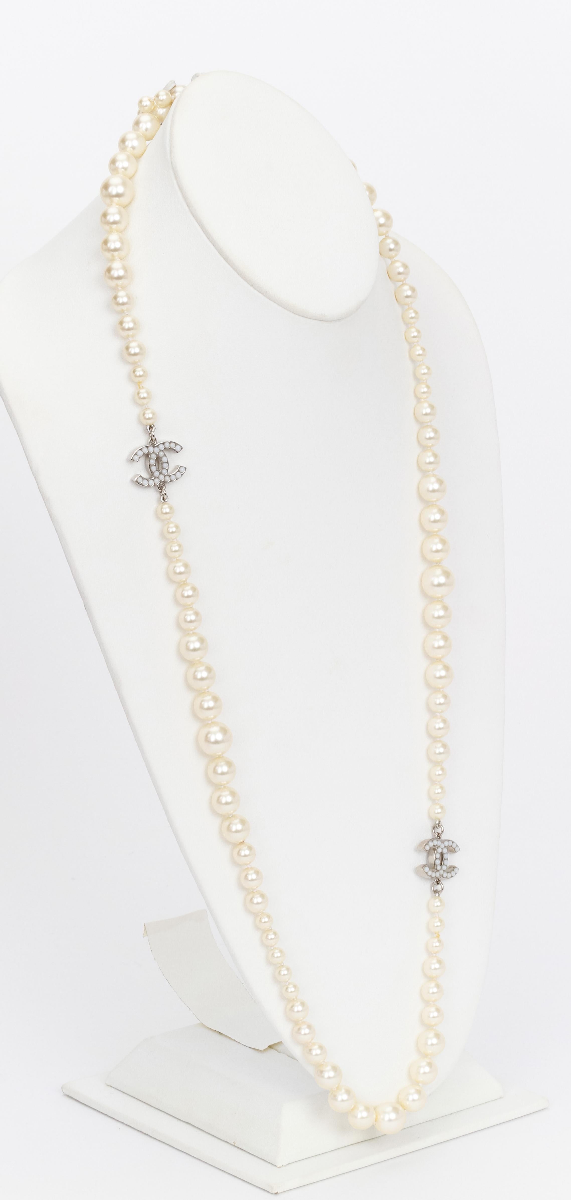 Chanel spring 2012 long pearl necklace with cc logo coins, L 35”, graduated faux pearls. Comes with original box.