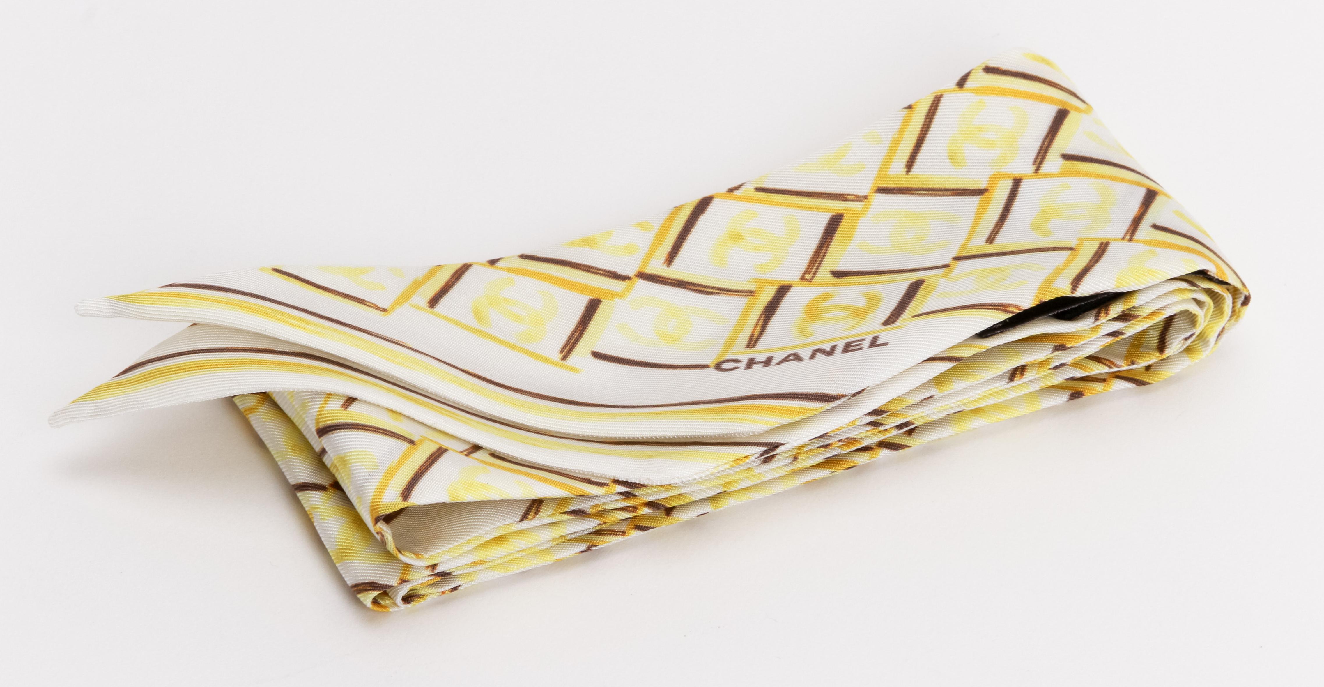Chanel brand new 100% silk twilly scarf. Geometric design. White, yellow and brown. Care tag attached.