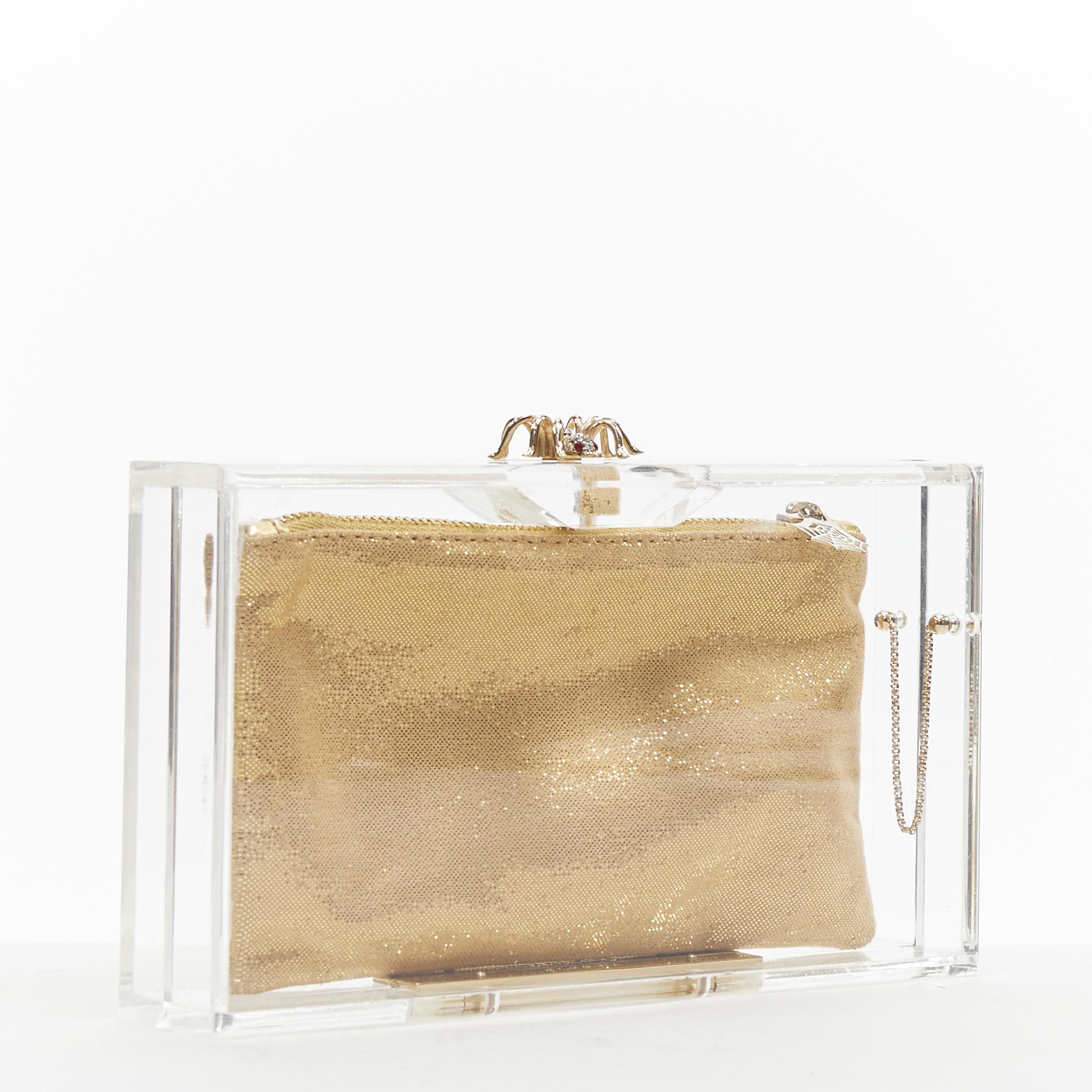 new CHARLOTTE OLYMPIA Pandora crystal spider clear perspex PVC box clutch Reference: TGAS/B00751 
Brand: Charlotte Olympia 
Model: Pandora box clutch 
Material: Plastic 
Extra Detail: Comes with 3 interchangeable pouch lining 

CONDITION: