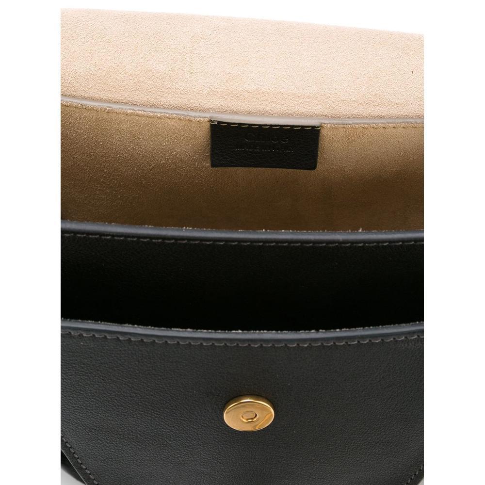 Lightly grained calf leather shoulder bag in black.
Adjustable leather and curb chain shoulder strap with post-stud fastening. 
Patch pocket at face. 
Flap compartment with magnetic press-stud fastening at suede sides. 
Foldover flap featuring hoop