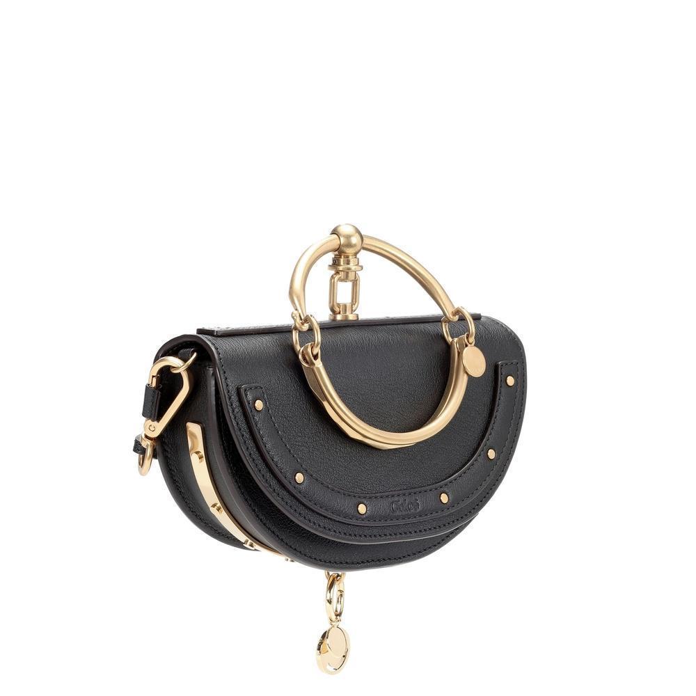Chloé's Nile Minaudière crossbody bag has the signature charm the brand is known for. Crafted from smooth beige-hued leather and accented with golden hardware, this half-moon style features a doorknob-inspired, oversized top handle for a distinctive