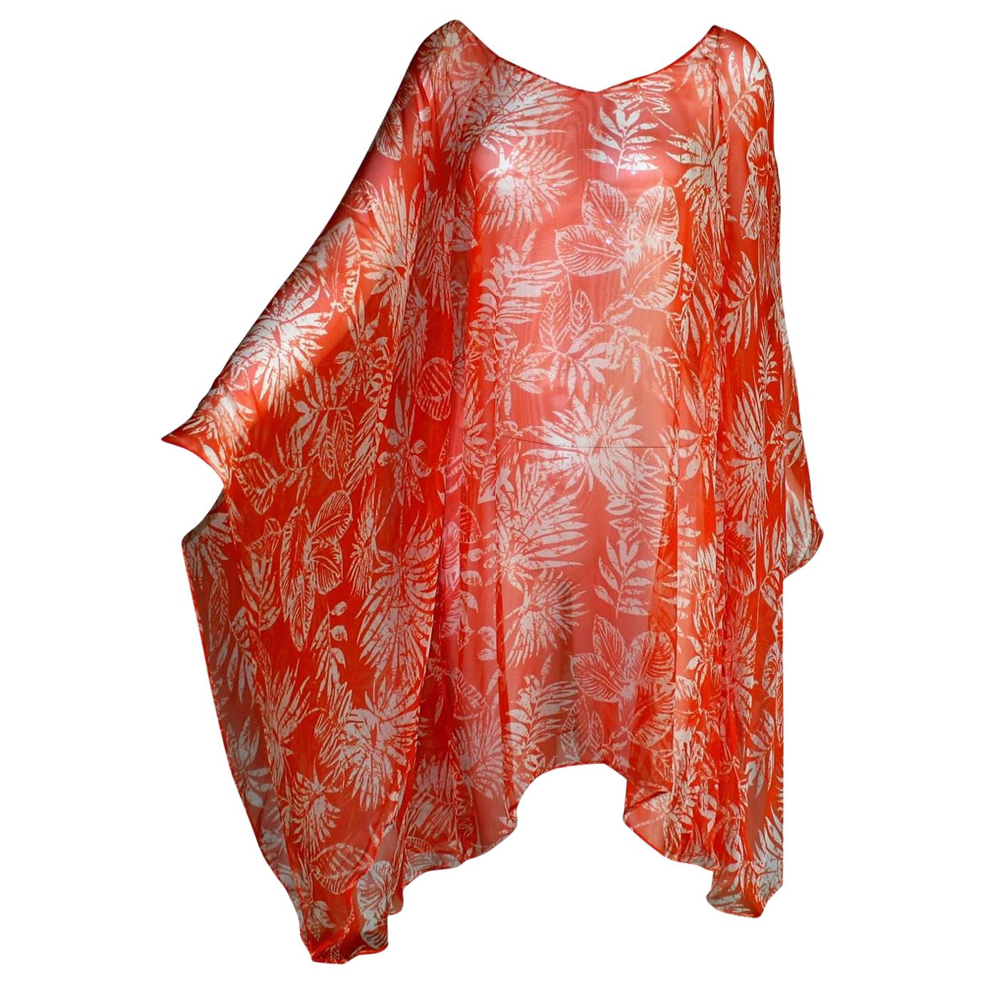 Amazing bright orange silk kaftan dress by Christian Dior
Consisting of two pieces, dress and belt
Finest chiffon silk
Botanic print
Batwing sleeves
Simply slips on
Metal plate 