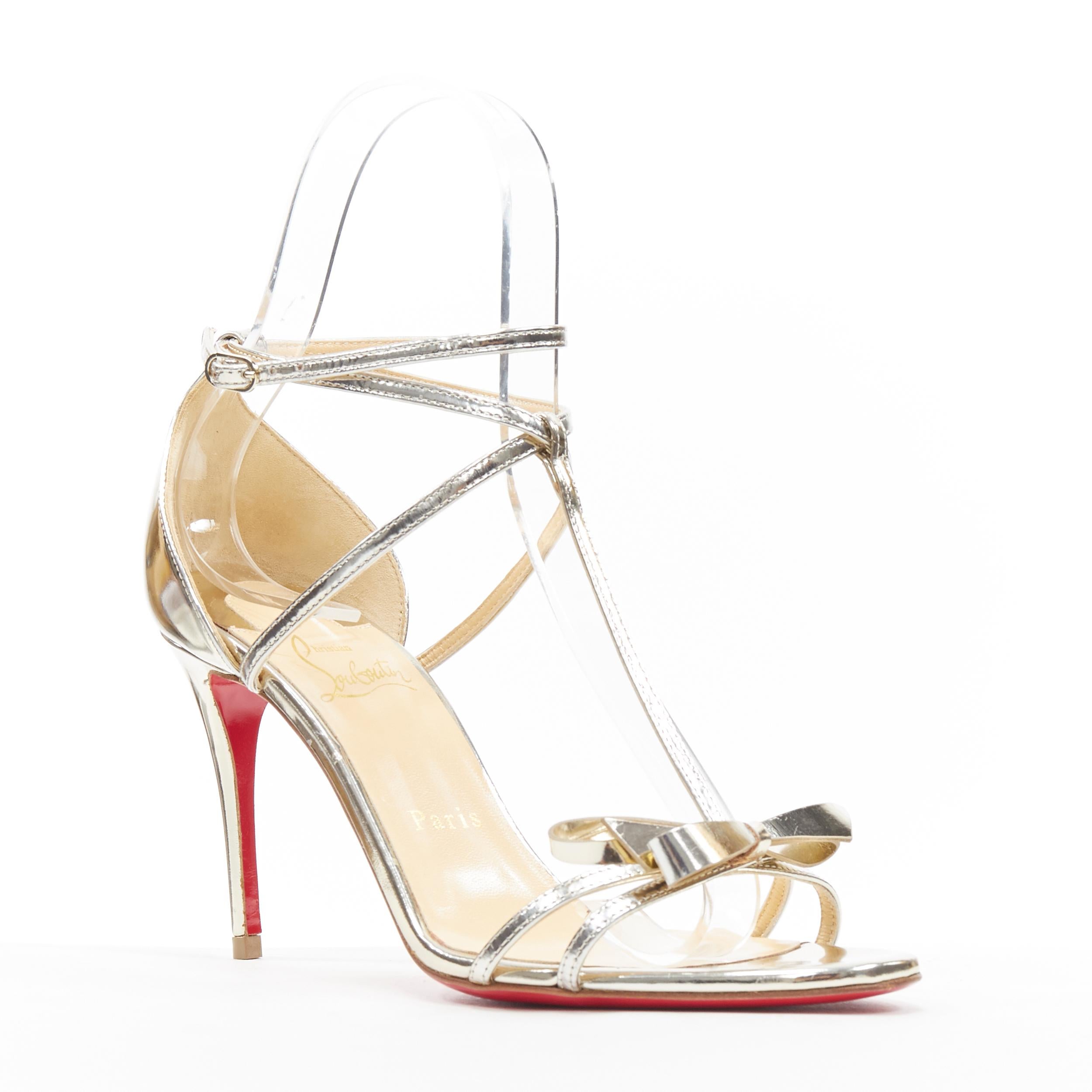 new CHRISTIAN LOUBOUTIN Blakissima metallic silver bow t-strap sandals EU37.5
Brand: Christian Louboutin
Designer: Christian Louboutin
Model Name / Style: Blakissima 
Material: Leather
Color: Gold; metallic champagne gold
Pattern: Solid
Closure: