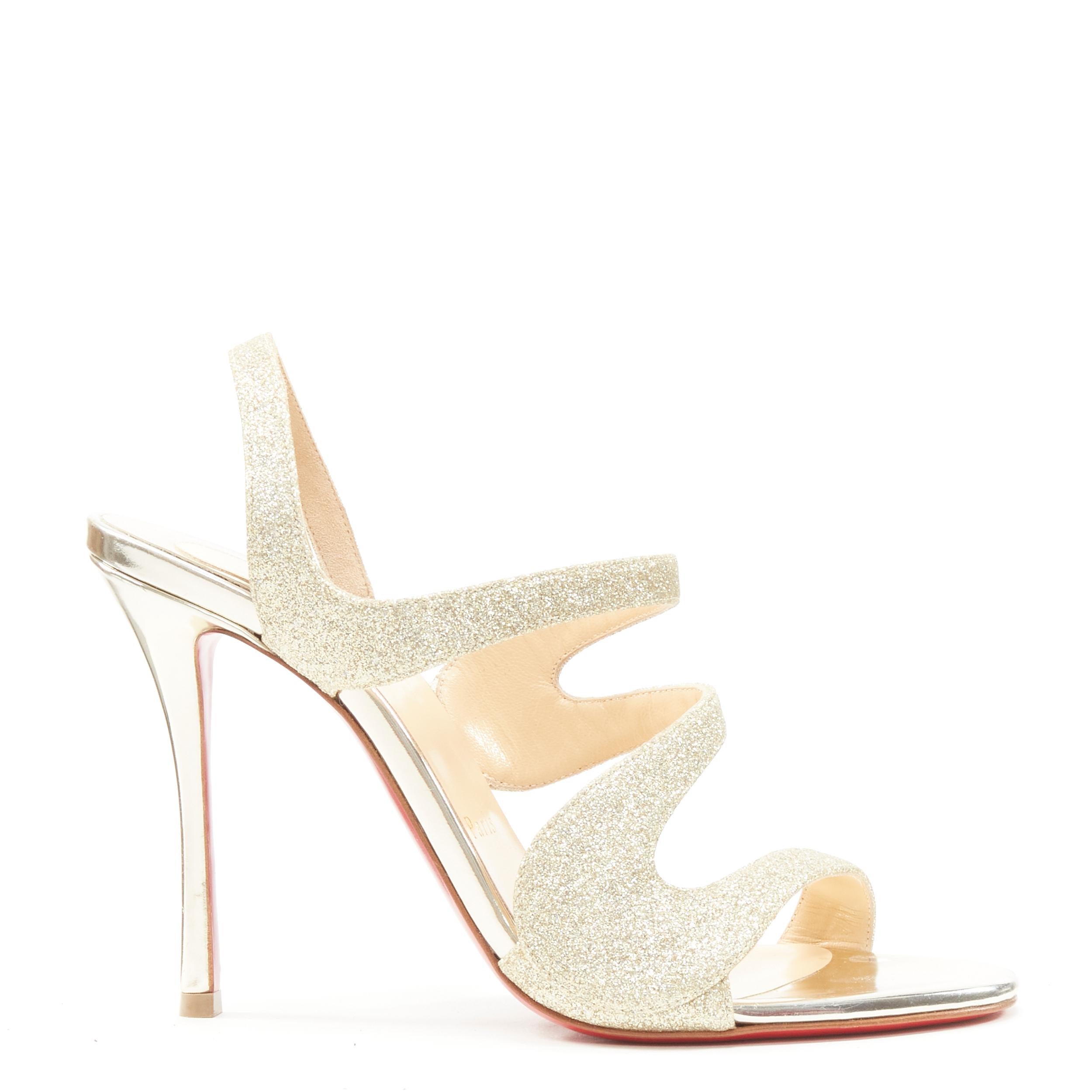 new CHRISTIAN LOUBOUTIN gold glitter swirly strap sling high heel sandal EU37.5 
Reference: TGAS/B02218 
Brand: Christian Louboutin 
Material: Leather 
Color: Gold 
Pattern: Solid 
Closure: Slingback 
Extra Detail: Gold-tone fine glitter leather.