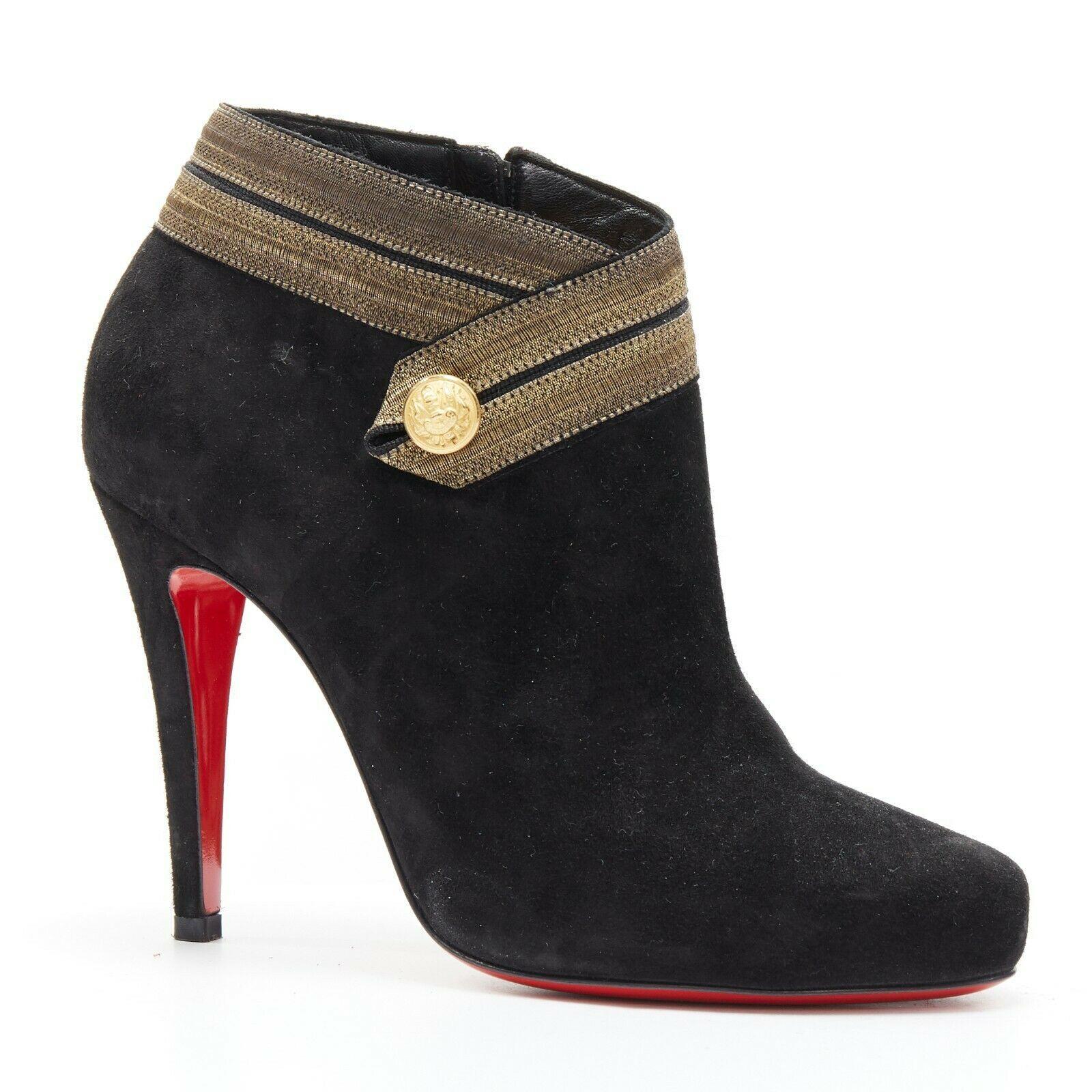 new CHRISTIAN LOUBOUTIN Marychal 100 black suede gold military trim bootie EU38
CHRISTIAN LOUBOUTIN
Marychal 100. 
Black suede leather upper. 
Gold embroidery trimming at opening. 
Gold-tone military decorative button. 
Almond round toe. 
Zipper