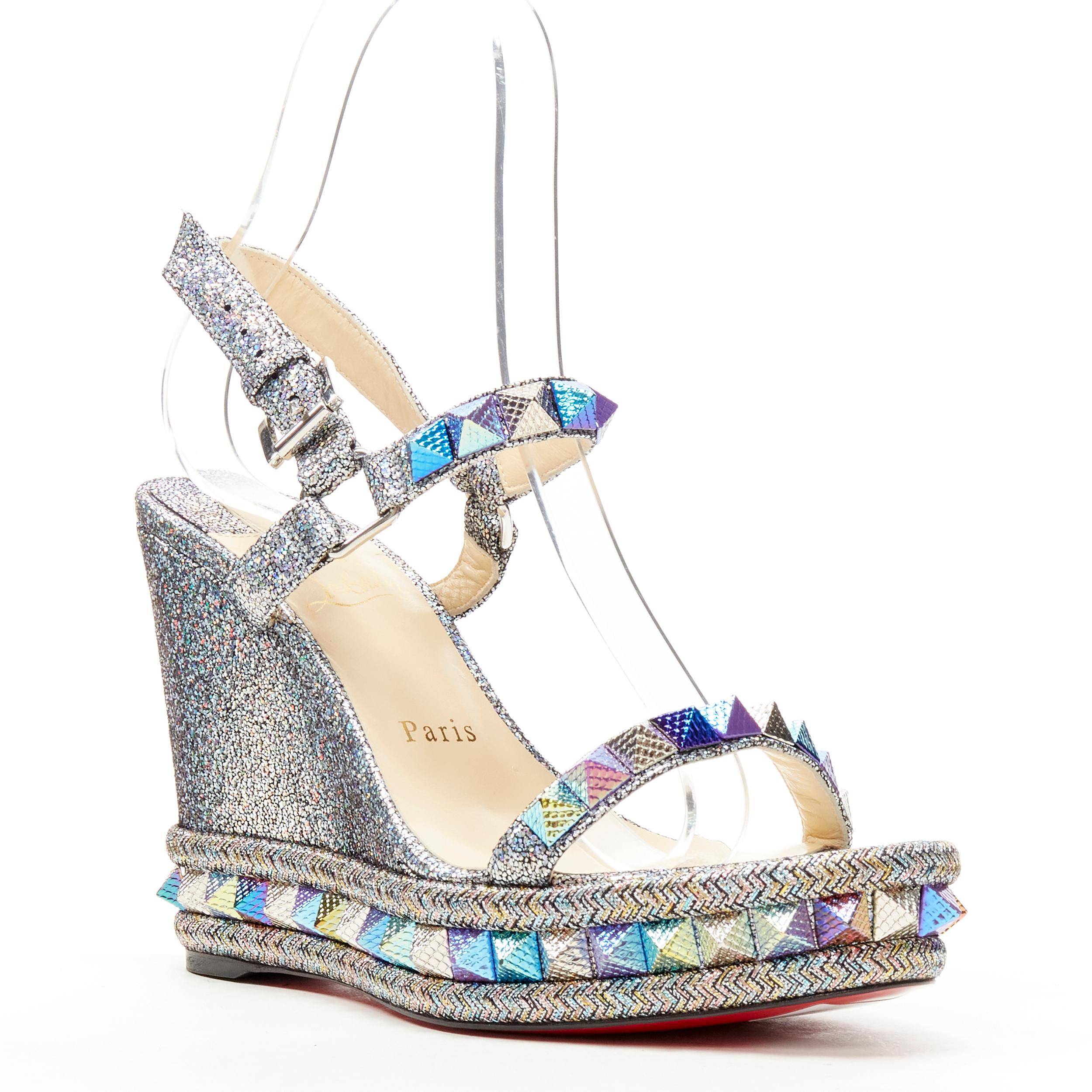 new CHRISTIAN LOUBOUTIN Pyraclou 110 silver lame stud platform wedge EU38 
Reference: TGAS/C01107 
Brand: Christian Louboutin 
Designer: Christian Louboutin 
Model: Pyraclou 110 
Material: Fabric 
Color: Silver 
Pattern: Solid 
Closure: Ankle Strap