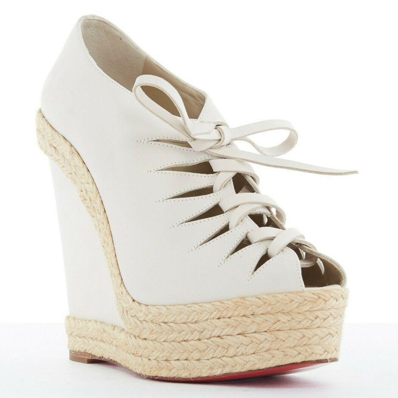 new CHRISTIAN LOUBOUTIN Viva Boom grey suede cut out espadrille wedge EU38 US8
CHRISTIAN LOUBOUTIN
Light grey suede upper. 
Cut out front. 
Suede leather laced front. 
Peep toe. 
Espadrille trimmed wedge heel. 
Covered heel. 
Tan leather lining.