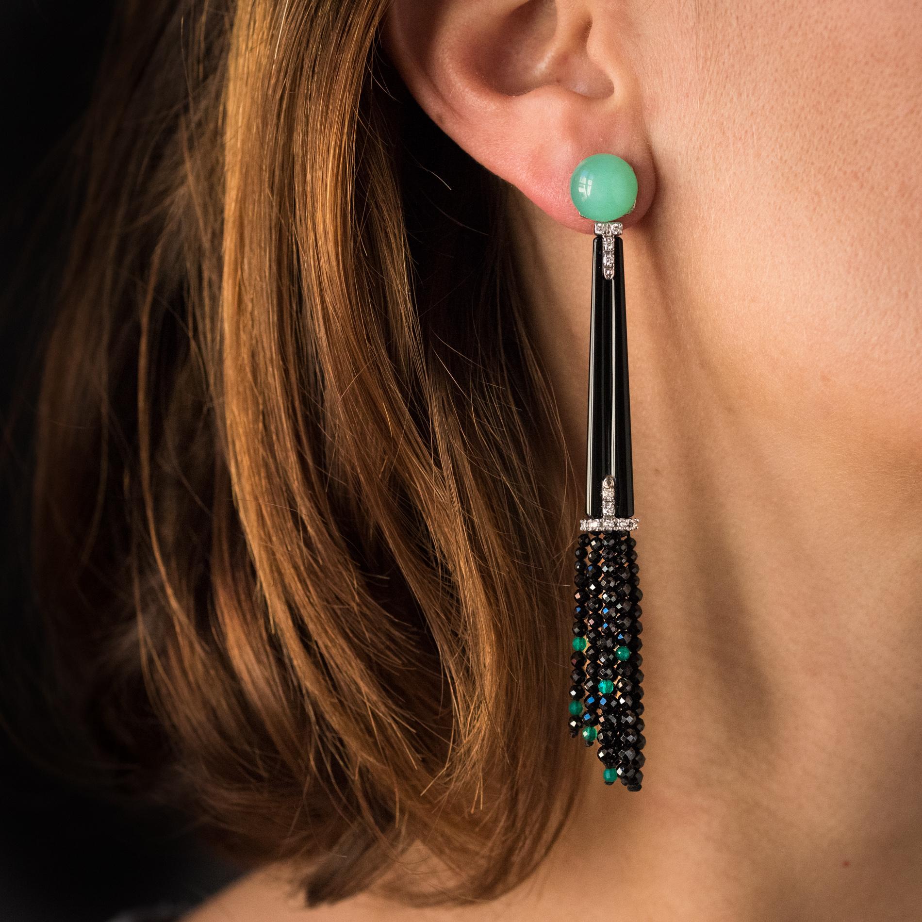 For pierced ears.
Earrings in 18 karats white gold.
Made of a chrysoprase cabochon, each long ear pendant is composed of a diamond-set T-pattern, attached to a long rectangular pattern with the same T-pattern at the base and ending with a tassel of