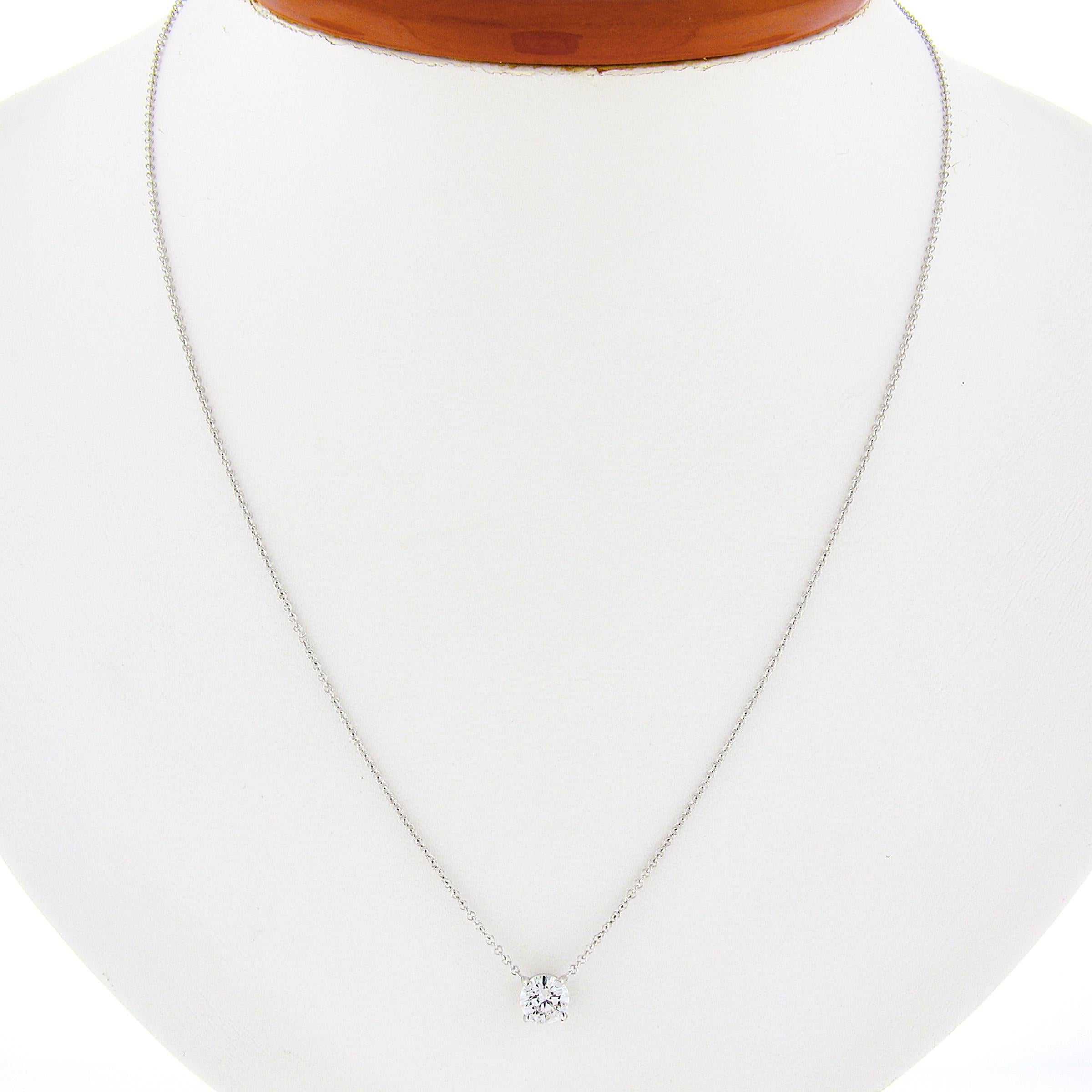 You are looking at a simple and classically styled diamond solitaire pendant that is newly crafted in solid 14k white gold. The round brilliant cut diamond on this pendant is neatly prong set in an open basket and weighs exactly 0.57 carats,