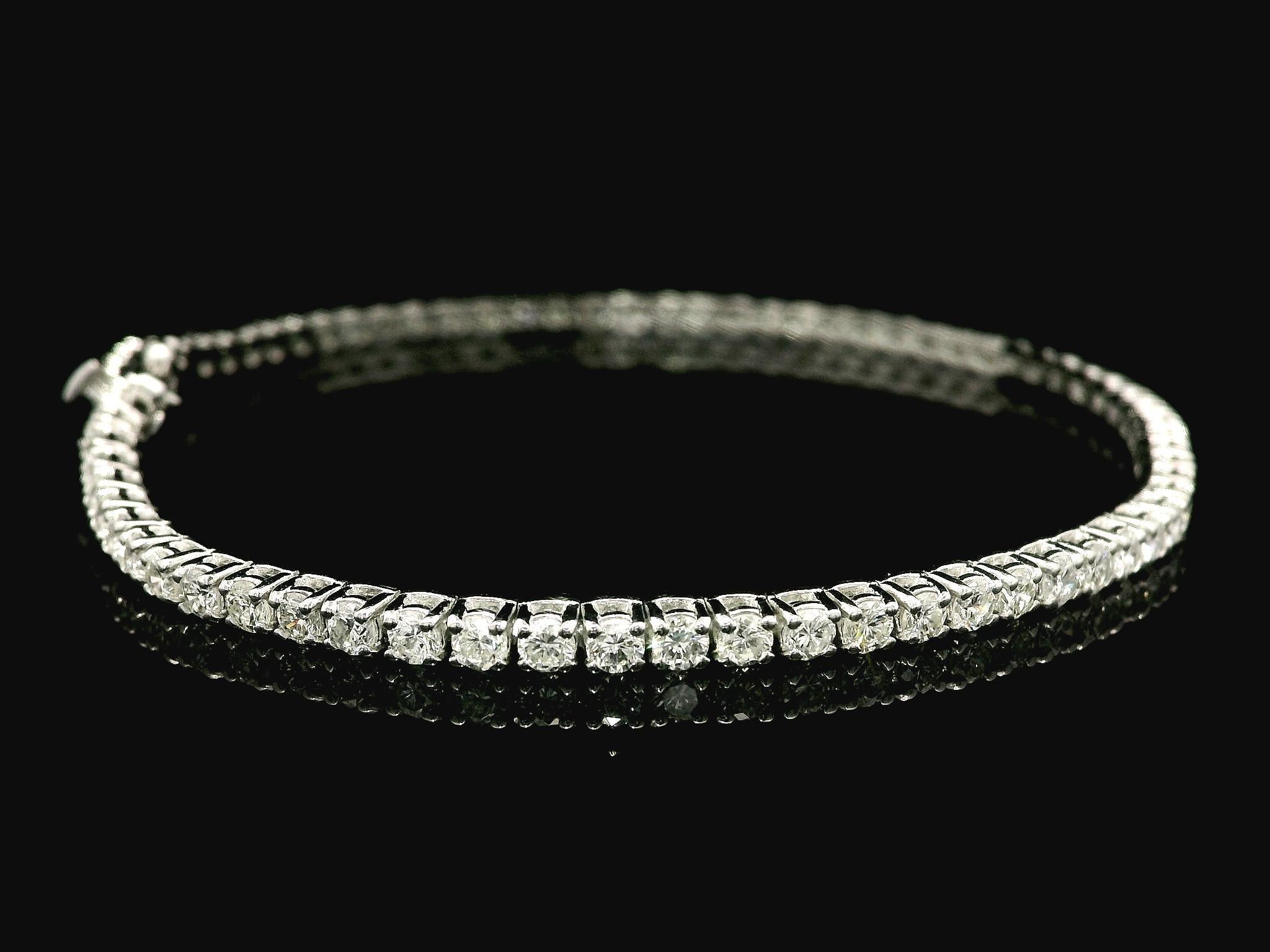 –Stone(s)–
(73) Natural Genuine Diamonds - Round Brilliant Cut - Prong Set - G/H Color - SI1/SI2 Clarity - 2.98ctw (exact)

Material: Solid 14k White Gold
Weight: 7.10 Grams
Type: Line Link Tennis
Length: Measures 7.0” Next to a Ruler, Will
